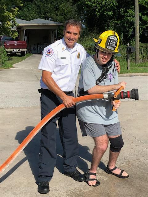 OCFRD Lt. Jesse Harris helped Eric Aach hold the fire hose during some outside time with the fire engine.