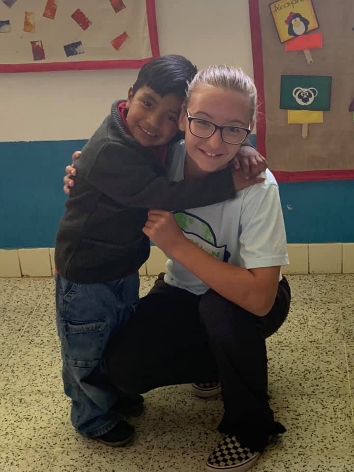 Joslyn Armstrong, right, loved on a student during a mission trip to Guatemala.
