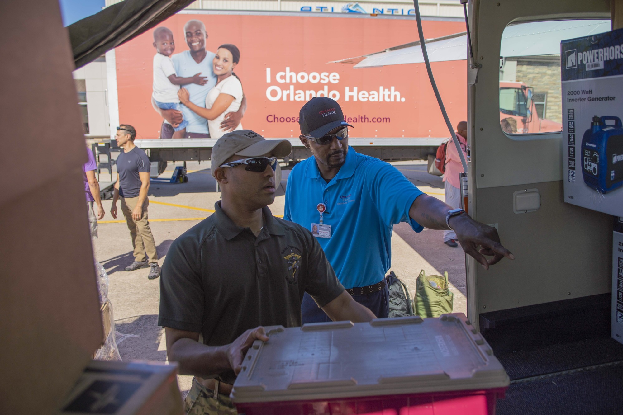Dr. Jonathan Higgins, Orlando Health surgeon, helped load supplies for the Bahamas.