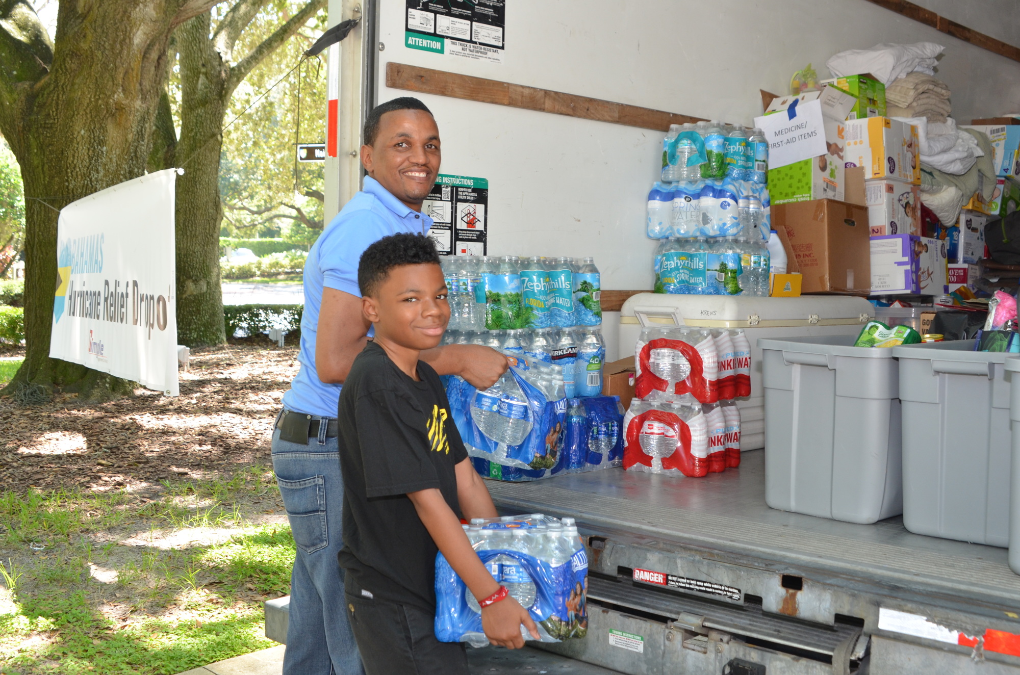 Lamont Wilson and his son, Justin, 13, helped fill the 26-foot truck set up outside Windermere Town Hall. They donated cases of water to the relief effort because they wanted to bless someone in need, Wilson said.