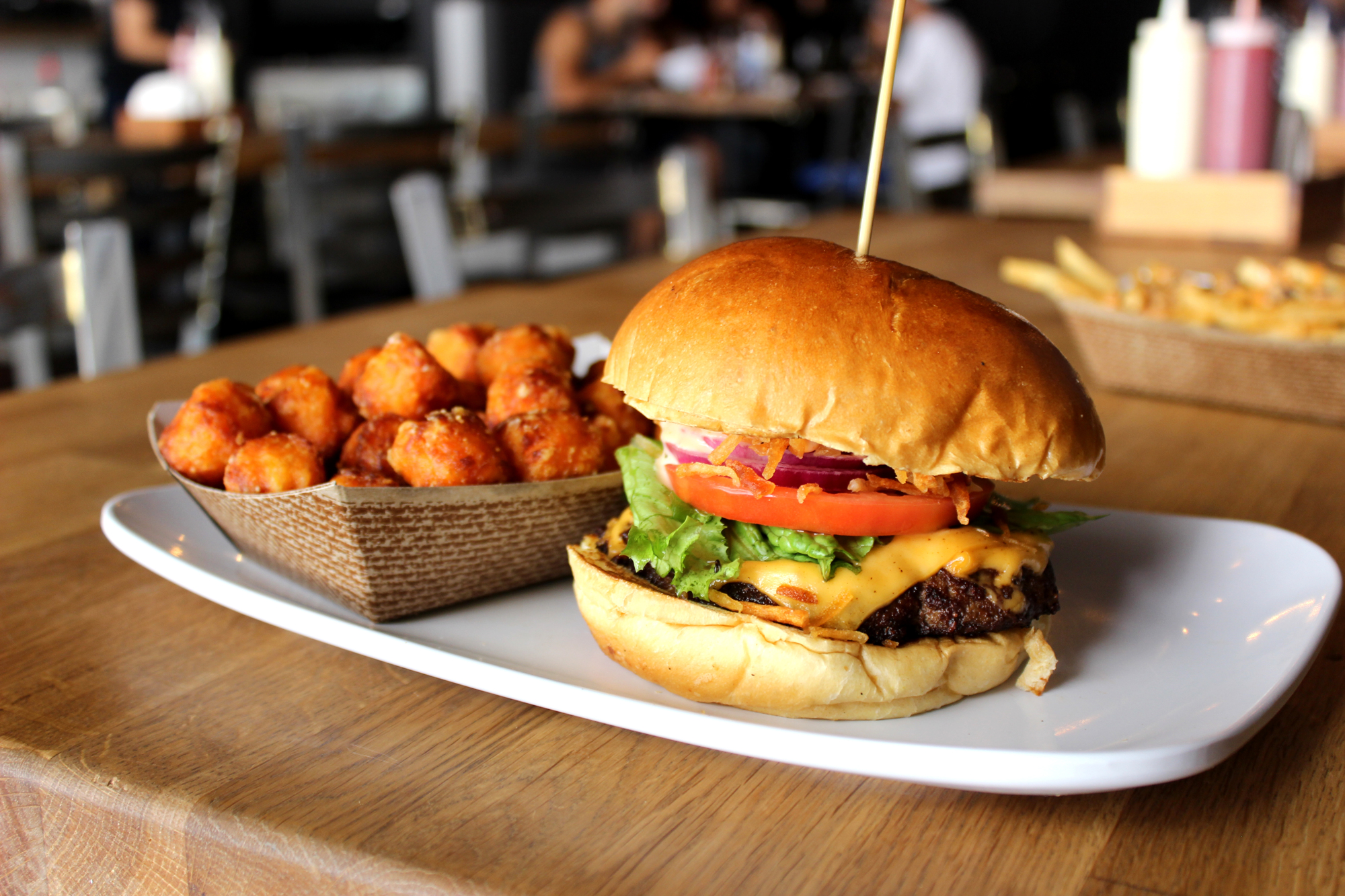 Pincho Factory's pincho burger with tater tots.