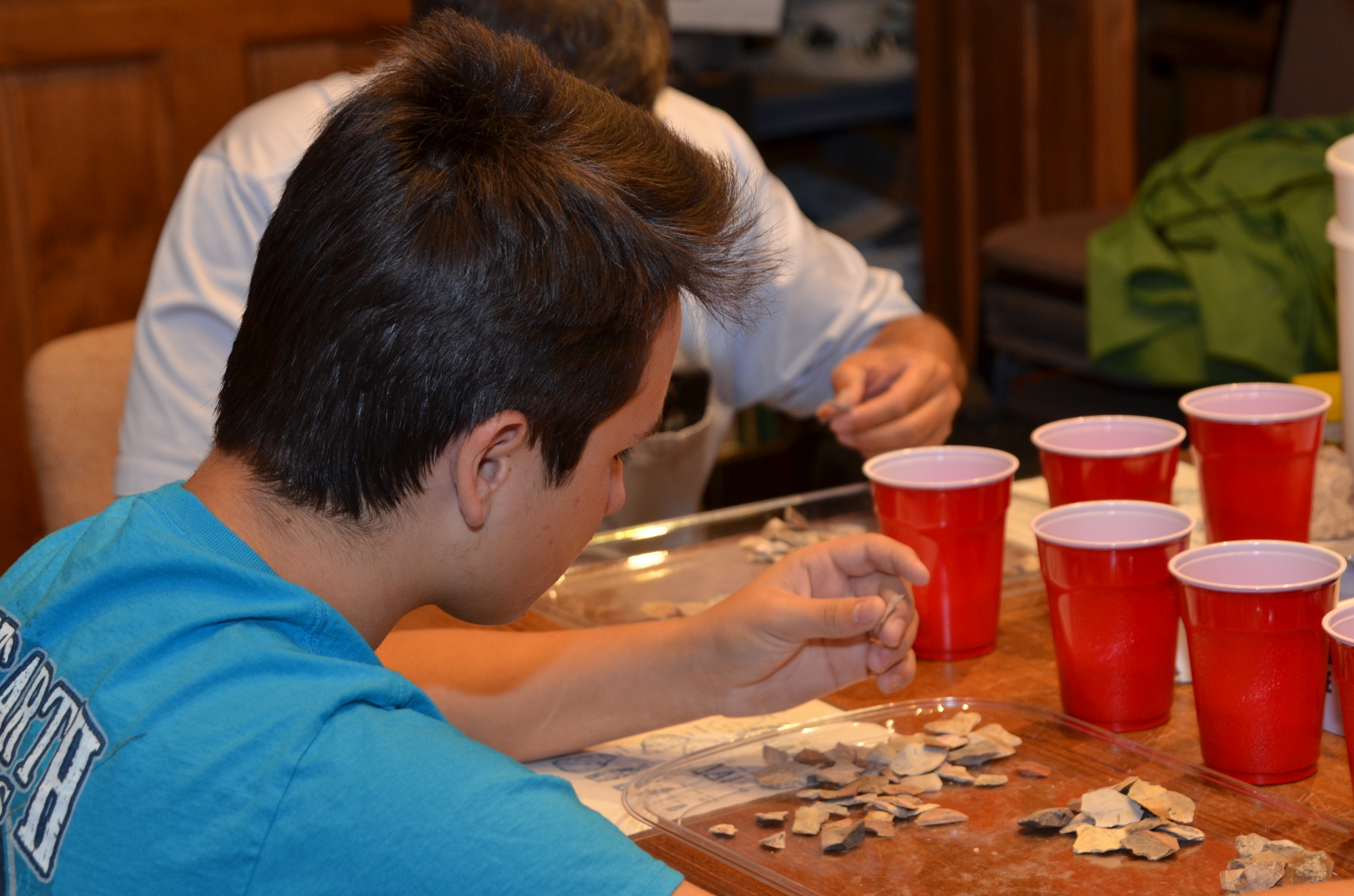 Alex Wells, of Ocoee, gets in his National Junior Honor Society hours by sorting lithic flakes at the Oakland Nature Preserve.