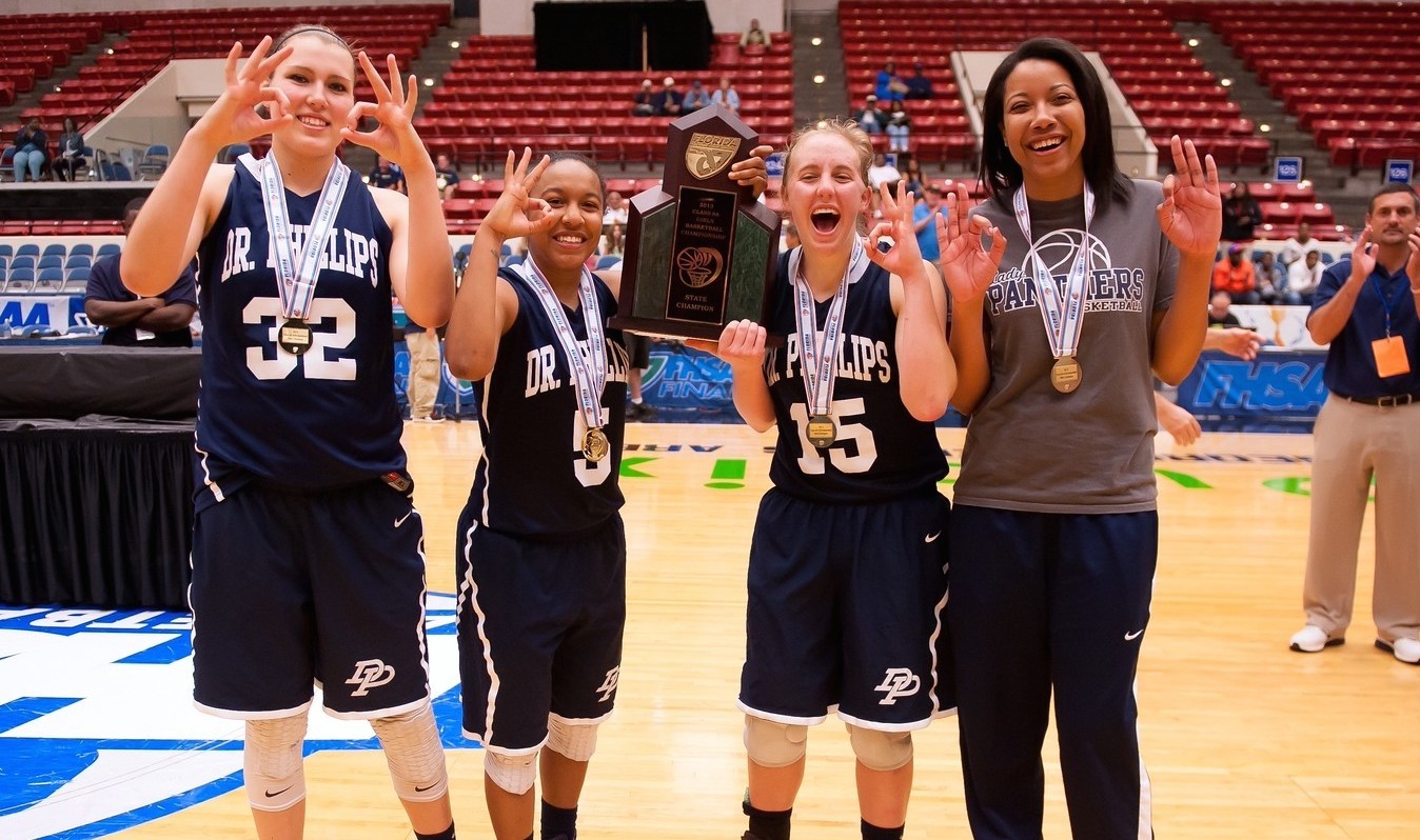 Hannah Schaible (No. 15) and teammates celebrate the Panthers' three-peat of girls basketball state championships. Photo by Dave Jester.