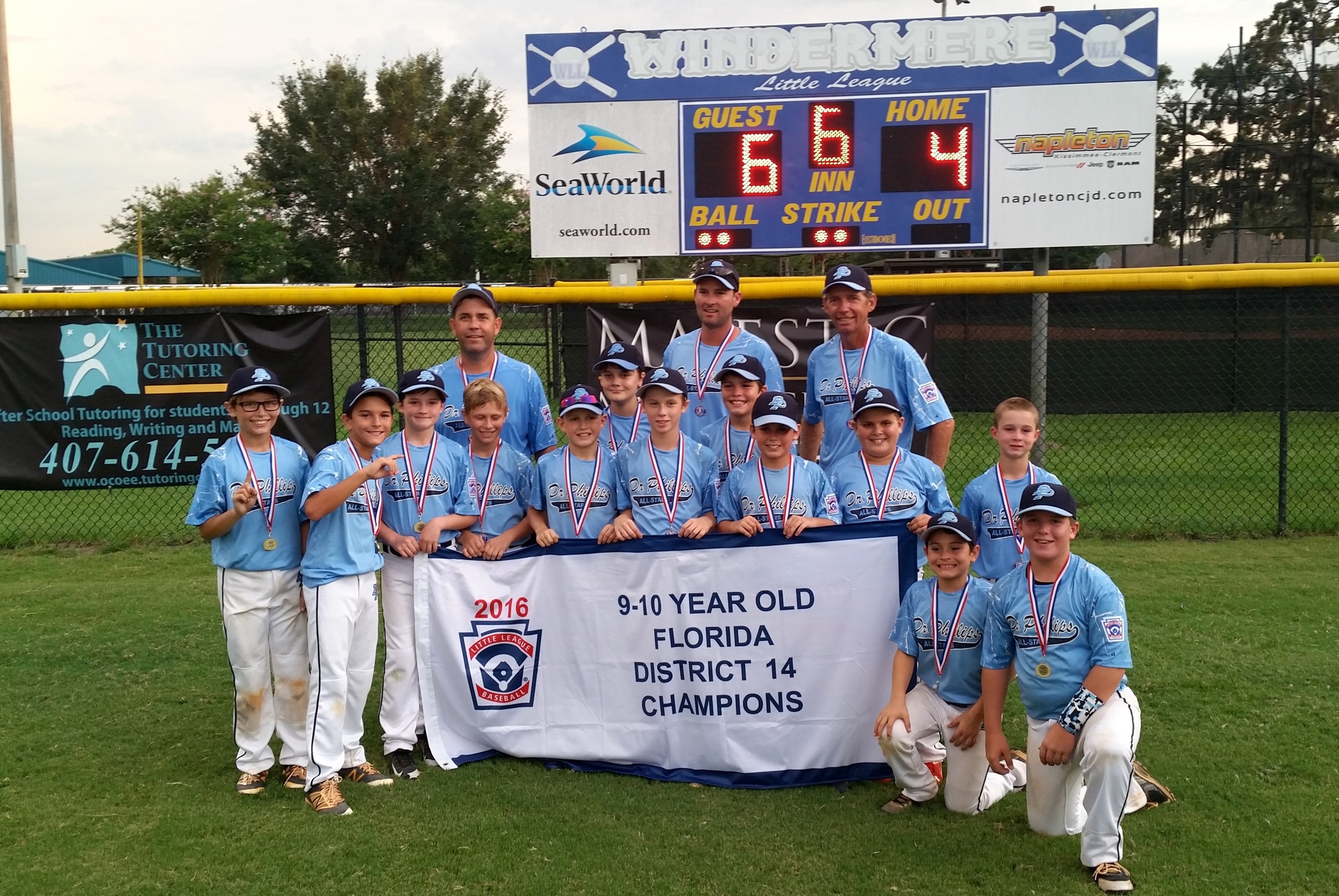 The Dr. Phillips Little League Minors (10U) All-Stars show off their district championship banner.