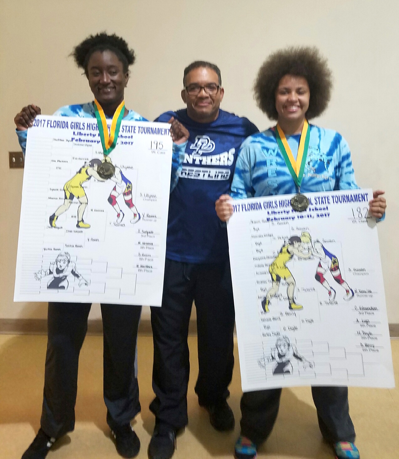 Coach Kirwyn Adderley with state champions Shedeline Ulyse and Shania Gowan.