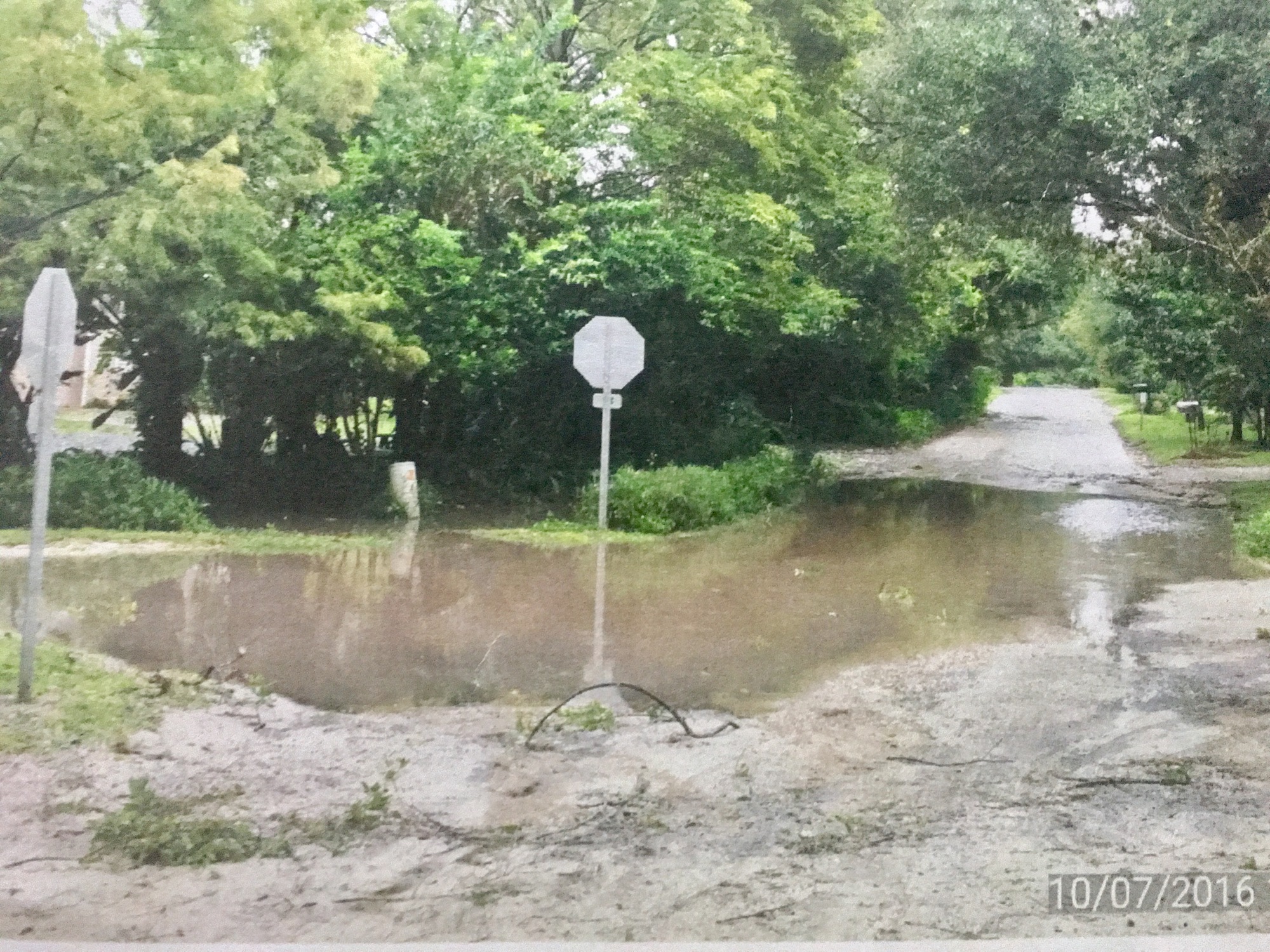 The area where the stop sign is located is prone to flooding on occasion.