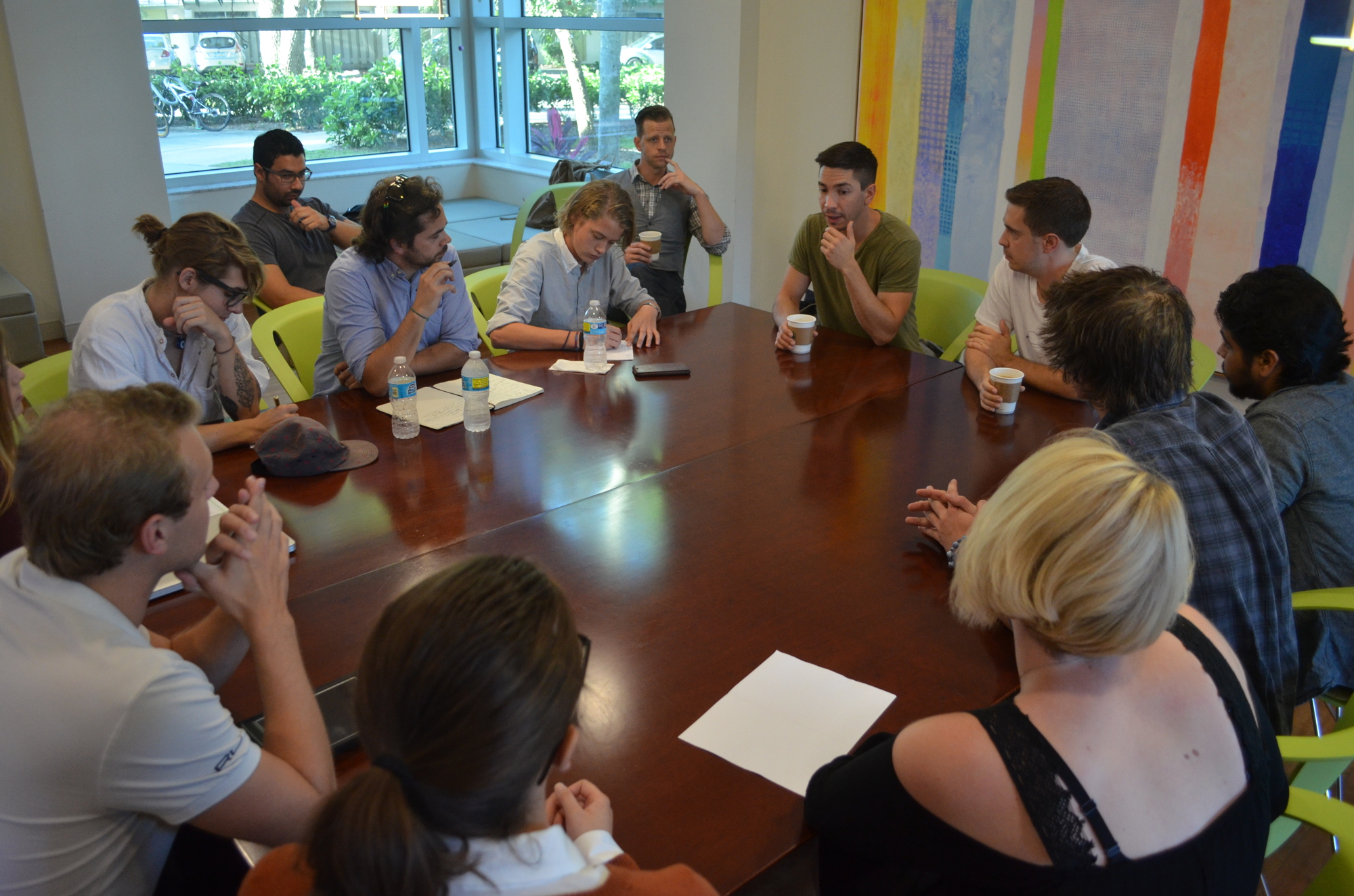 Justin and Christian Long (center) sit around with their team of Ringling College upperclassmen film students to discuss the initial phases of their travel/comedy web series set in Sarasota.