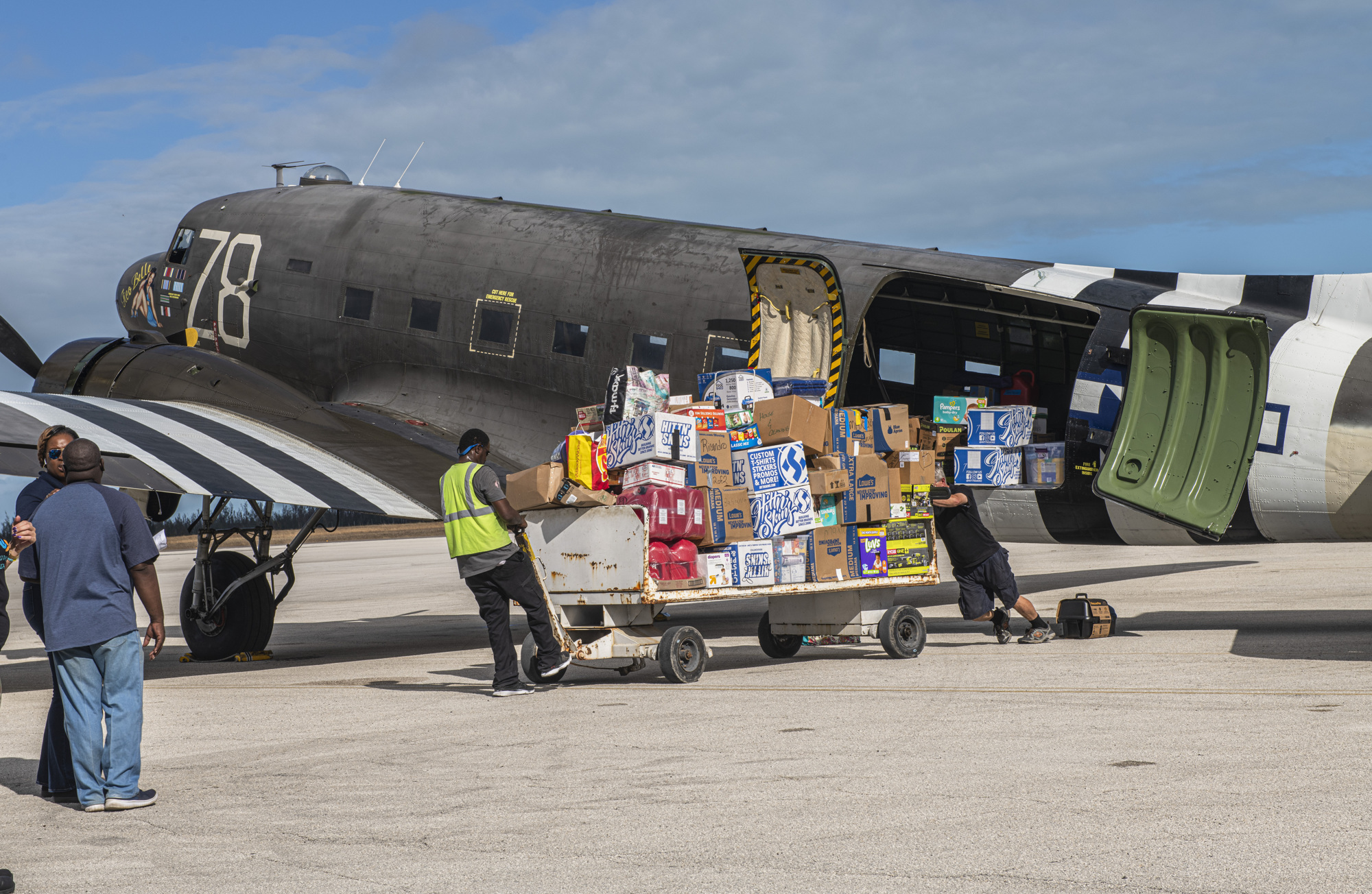 Dozens of boxes of supplies were unloaded from an old WWII airplane called Tico Belle. Although Carey Sheffield didn’t fly into the Bahamas on that particular plan, she did have a hand in delivering the supplies it carried.