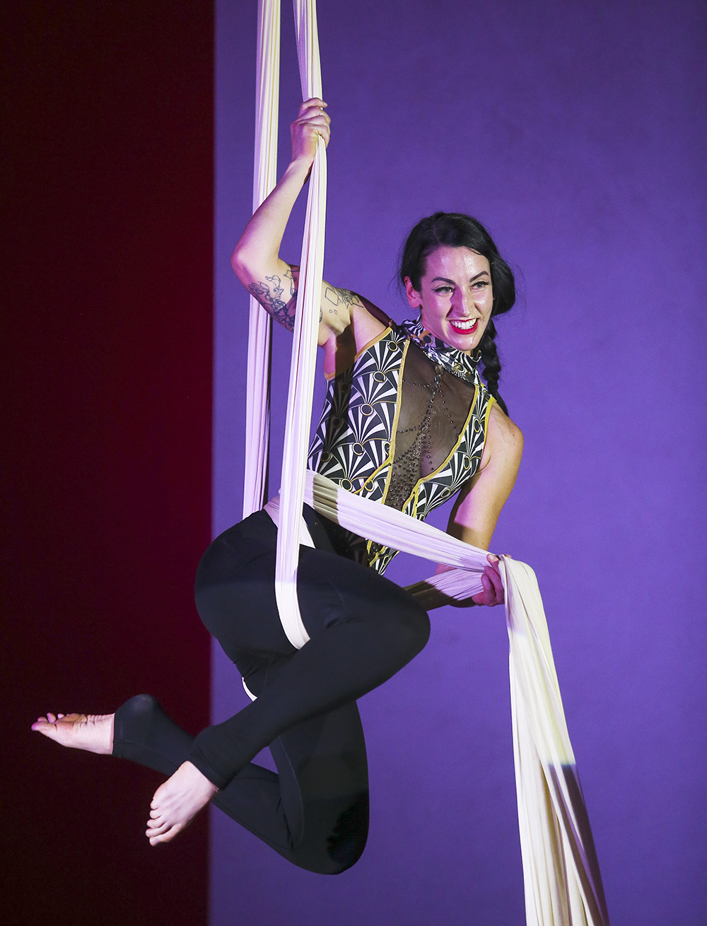 Aerialist Laura Gwendolyn Burch soars over audiences on silk and single point dance trapeze. 