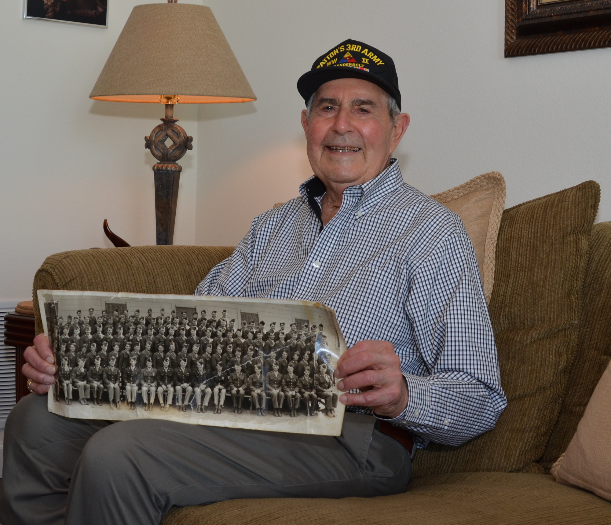 World War II veteran Gilbert Waganheim has kept a photo of his fellow soldiers. He is sixth from the left on the second row from the top.