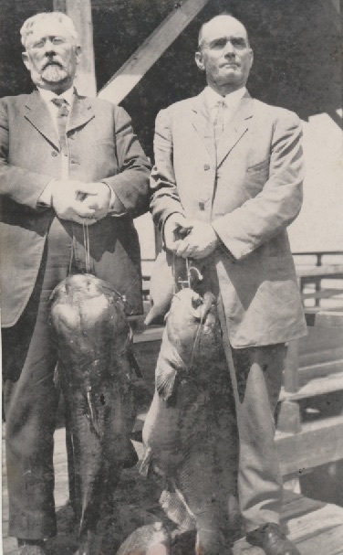 James Lafayette Dillard and B.T. Boyd showed off two large fish, presumably caught in Lake Apopka.