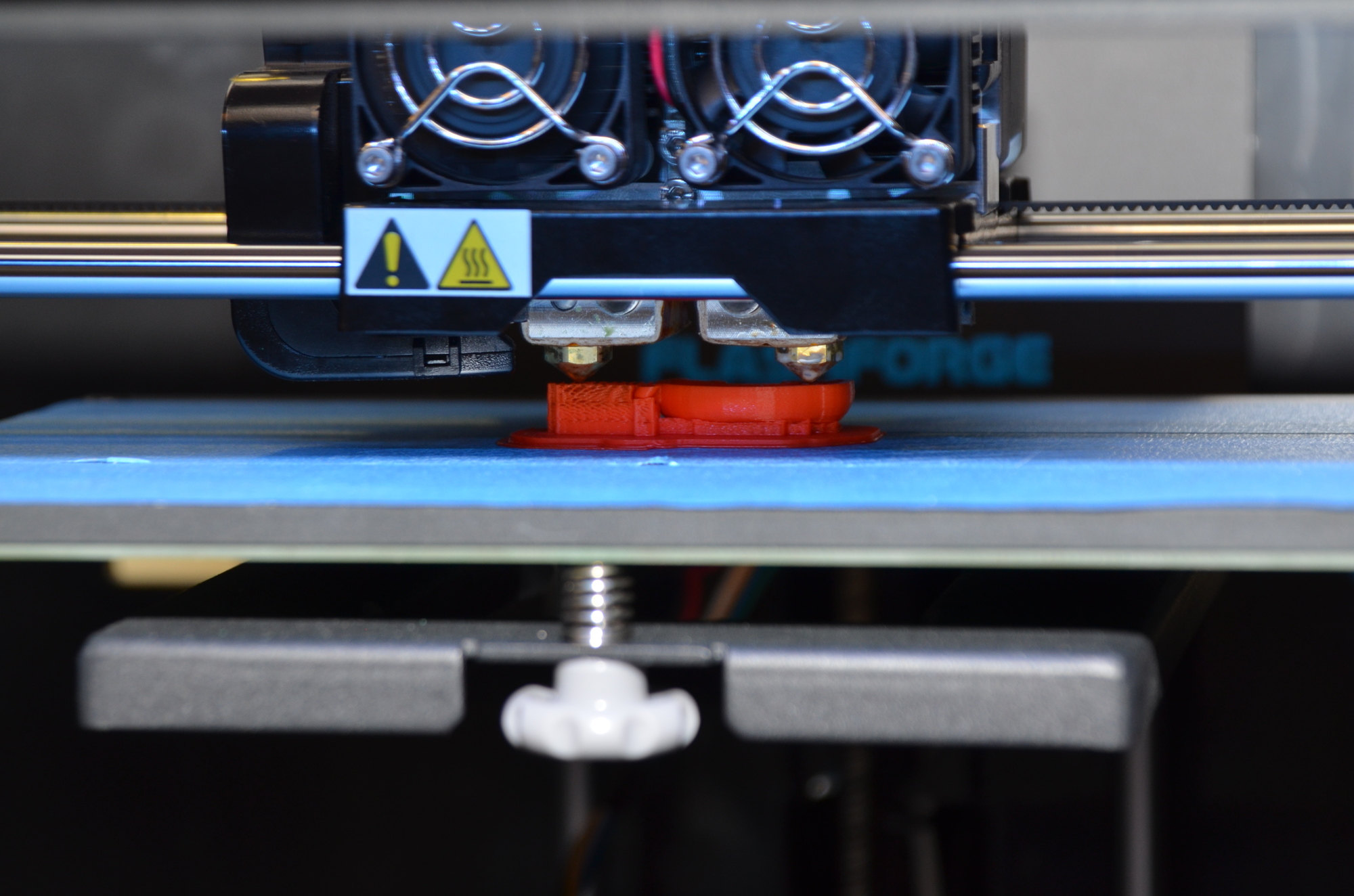 A staffer at the Orlando branch prints a miniature telephone on the 3D printer.