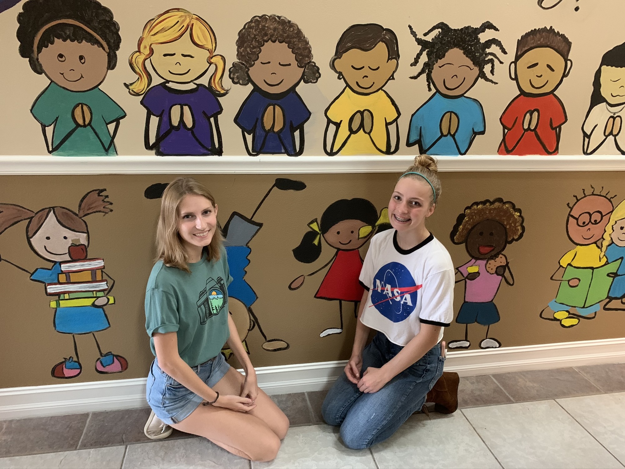 Girls representing the group Girl Spirit donated their time recently to help paint murals and other works of art at All Kidz Preschool.  (Courtesy Lana Wilkens-Gies)