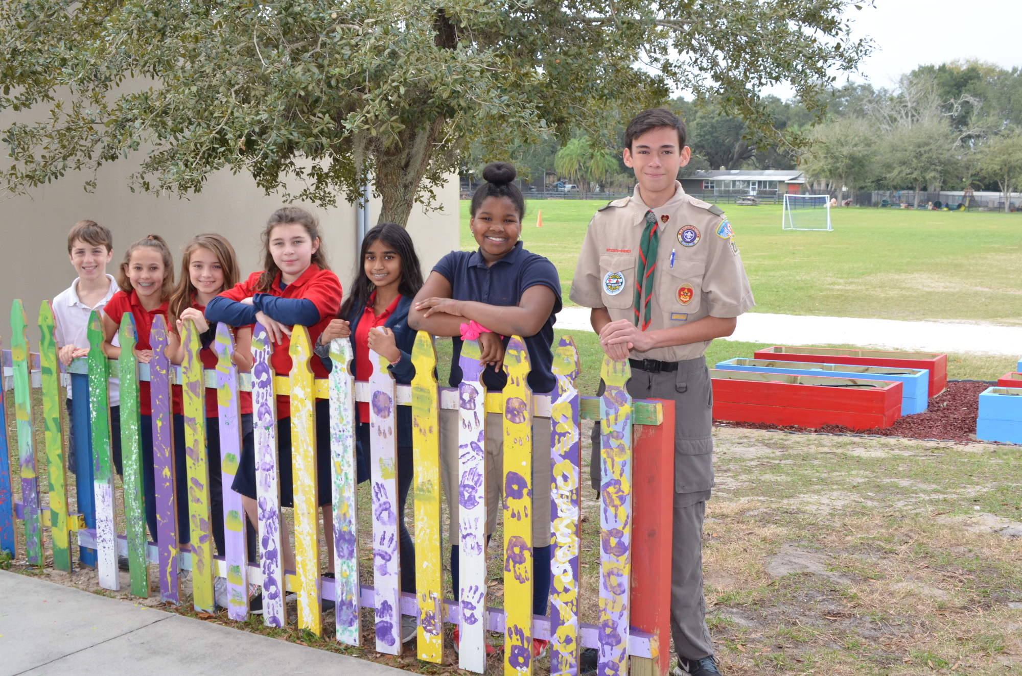 Eagle scout candidate Jonathan Le Morvan, right, with the fifth graders who painted the picket fence near the garden: Hayden Dalton, left, Kenleigh Swindle, Reagan Rittenberry, Ariceli Resto, Natalia Sant and Kiana Grant.