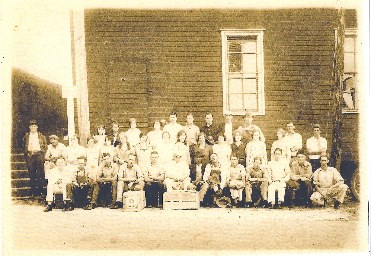 Employees gathered for a group photo outside the Fuller Packinghouse around 1920.
