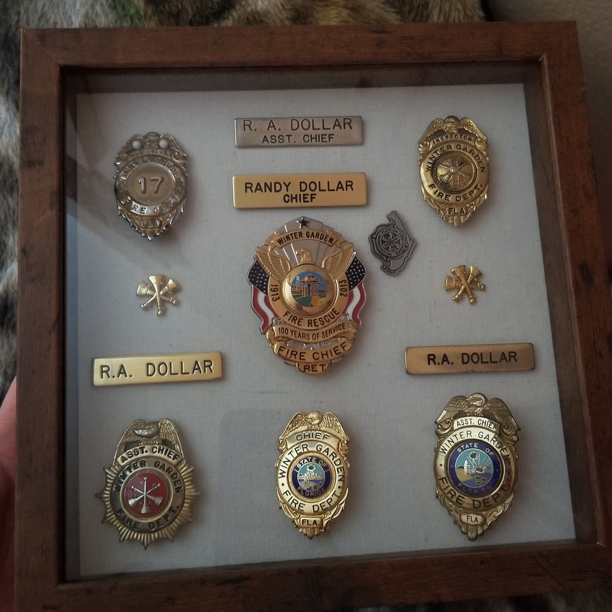 Randy Dollar's daughter, Amanda Williams, made him a shadowbox with all of his fire department badges just before he died.