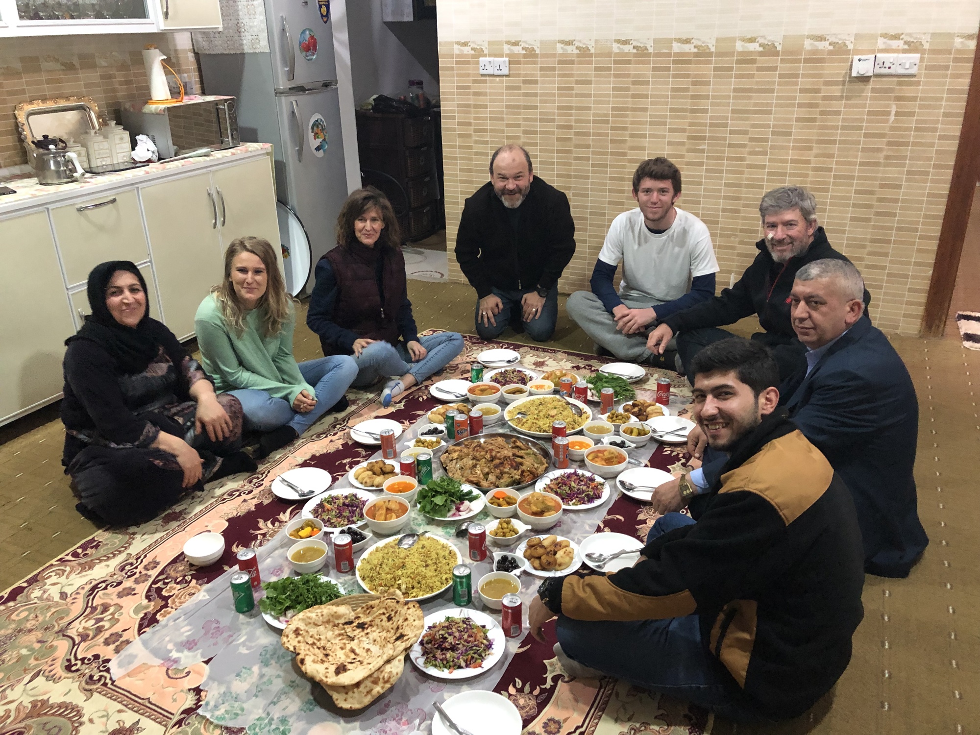 Love for the Least members sit down for an Iraqi meal.