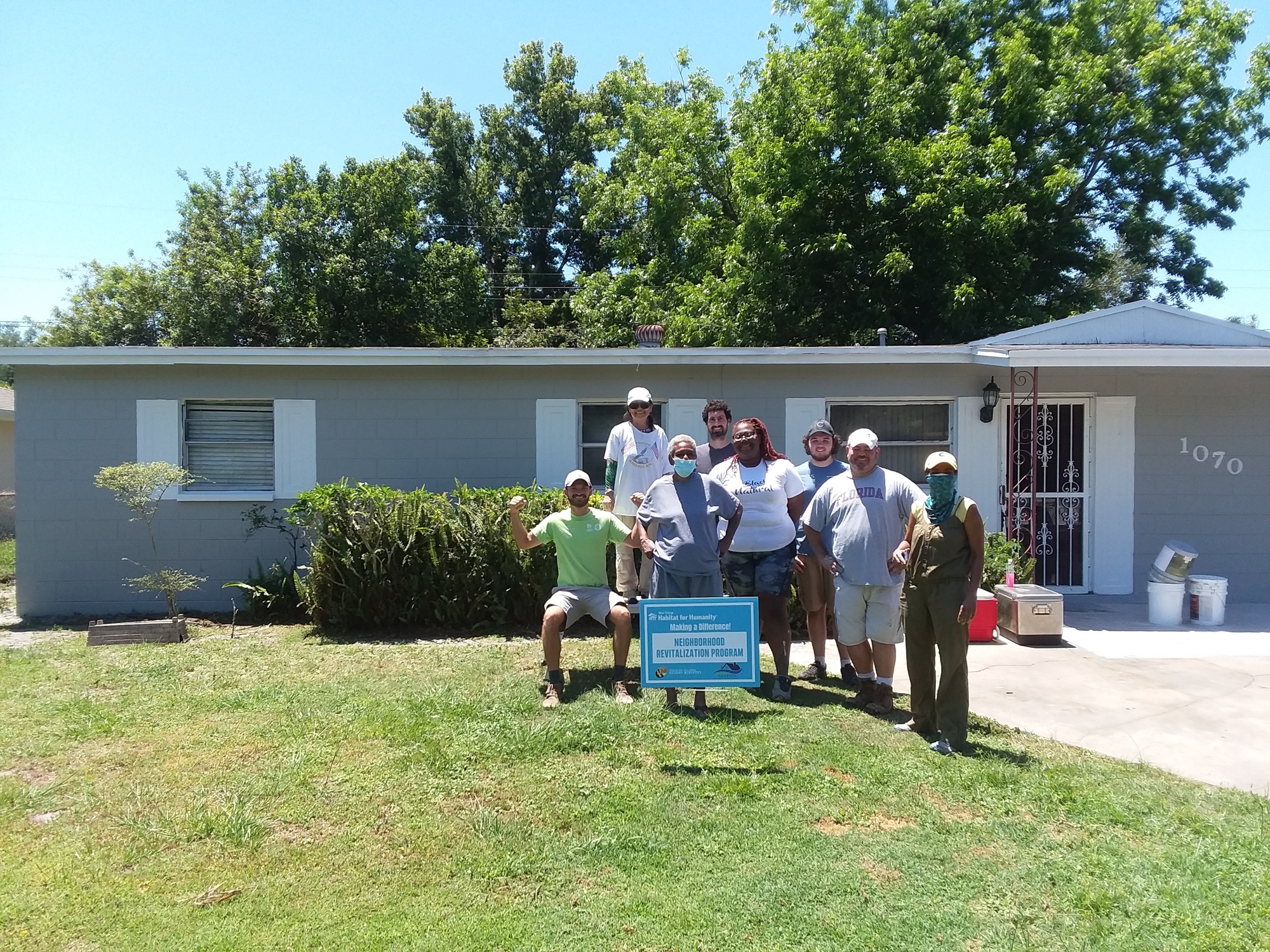 Shannon Ligon, center, has been putting in sweat-equity hours by painting other homes in the community.