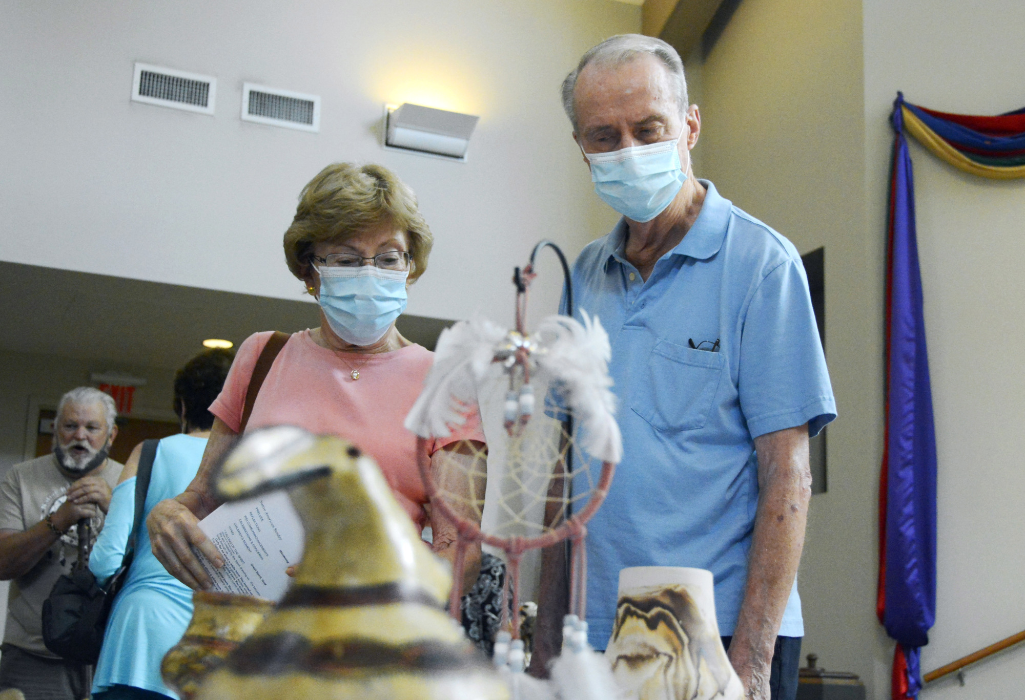 Gail and Fred Engelking inspect Native American artifacts displayed for the service.