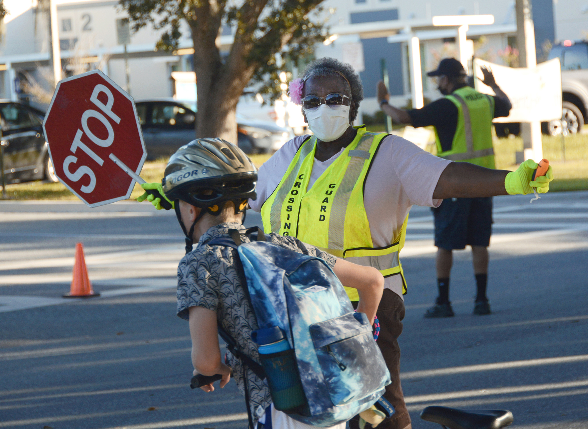 Ruth Marcus helps pedestrians on their way to Windermere Elementary School.