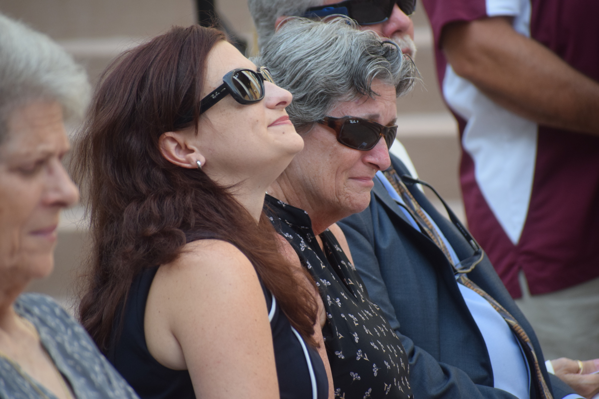 Lindsey Post and Karen Clark hold back emotions as their father and husband Deputy Douglas Clark is honored at the Manatee County Law Enforcement Memorial Service.
