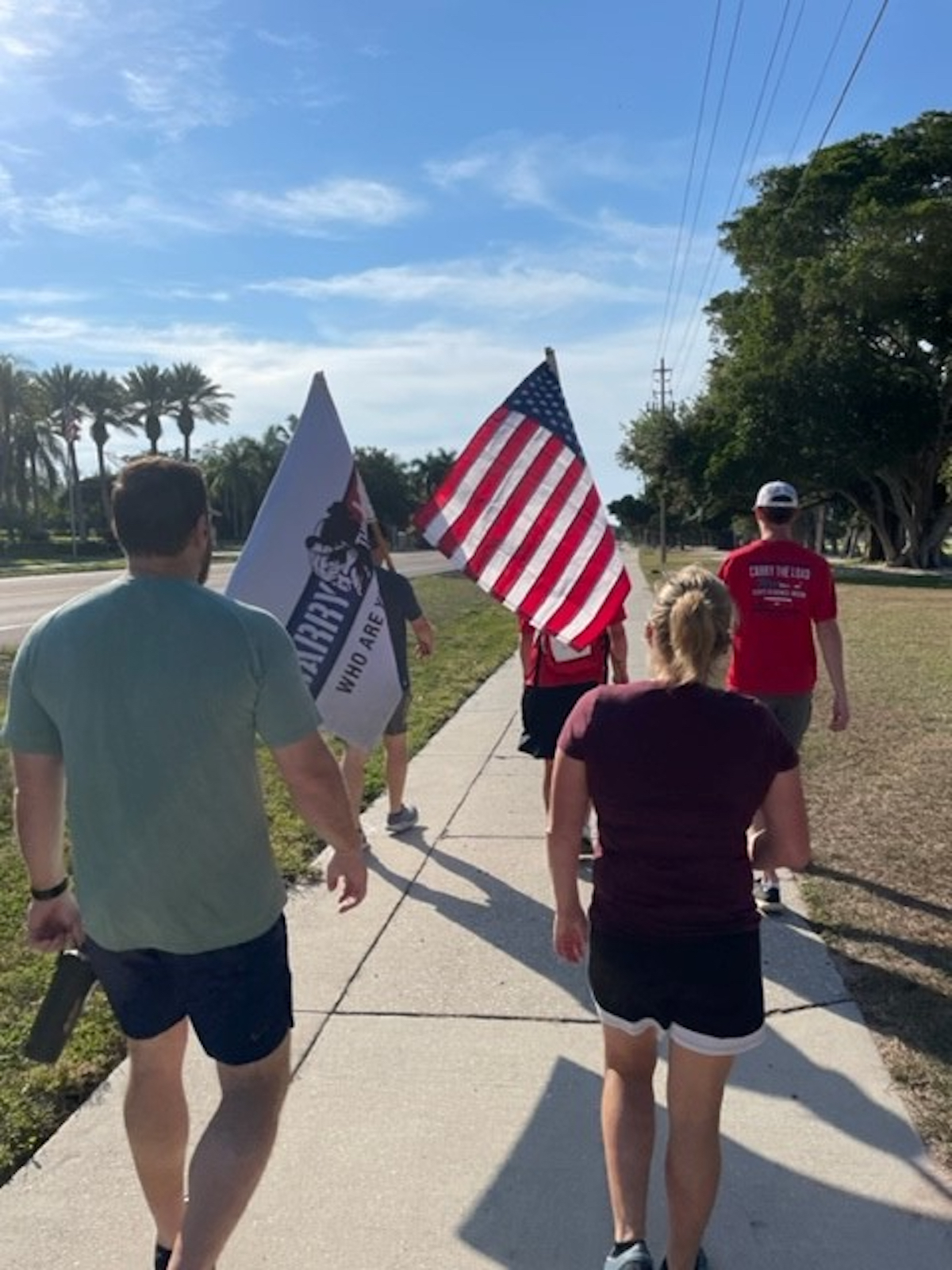 Participants carried flags as they made their way north. Photo courtesy of Tina Adams.