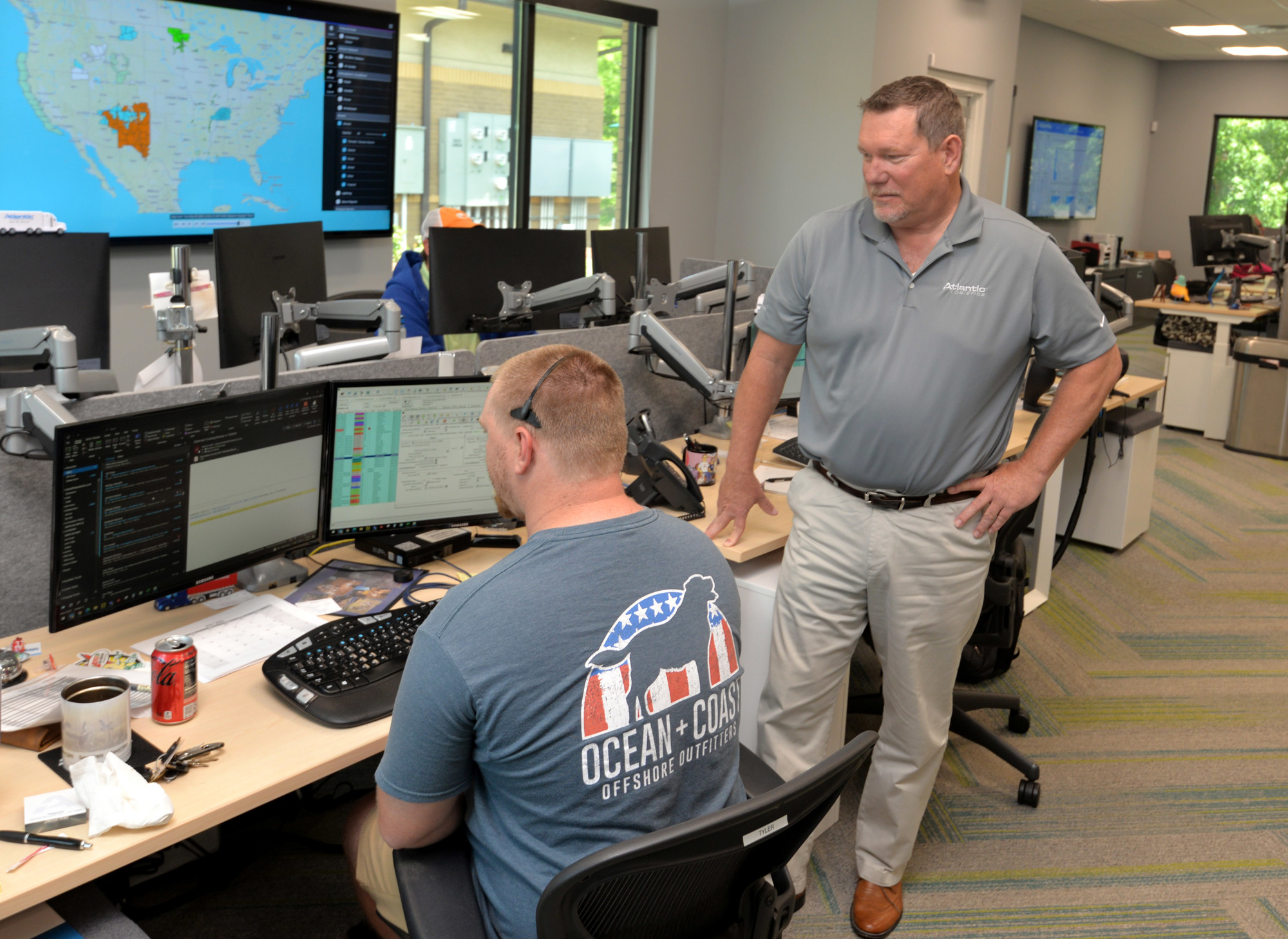 Johnnie Greene talks with a worker at the Atlantic Logistics offices at 3003 Claire Lane, Suite 303, in Mandarin. The company. founded in 2001, has about 50 employees. (Photo by Dede Smith)