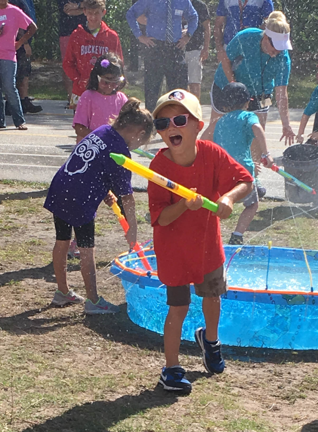 Buster Bossardet takes aim at his team's bucket during the Water Blaster activity. Photo courtesy of Old Kings Elementary School