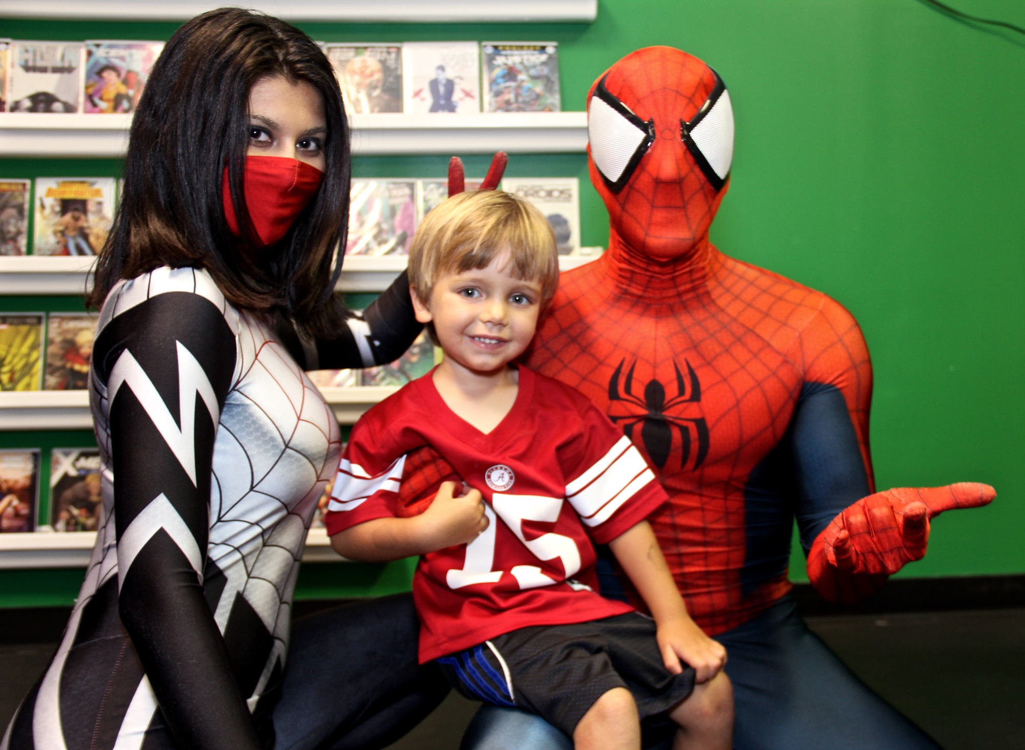 Theo Brackin, center, was excited to meet Spider-Man and Silk on Saturday, July 8.