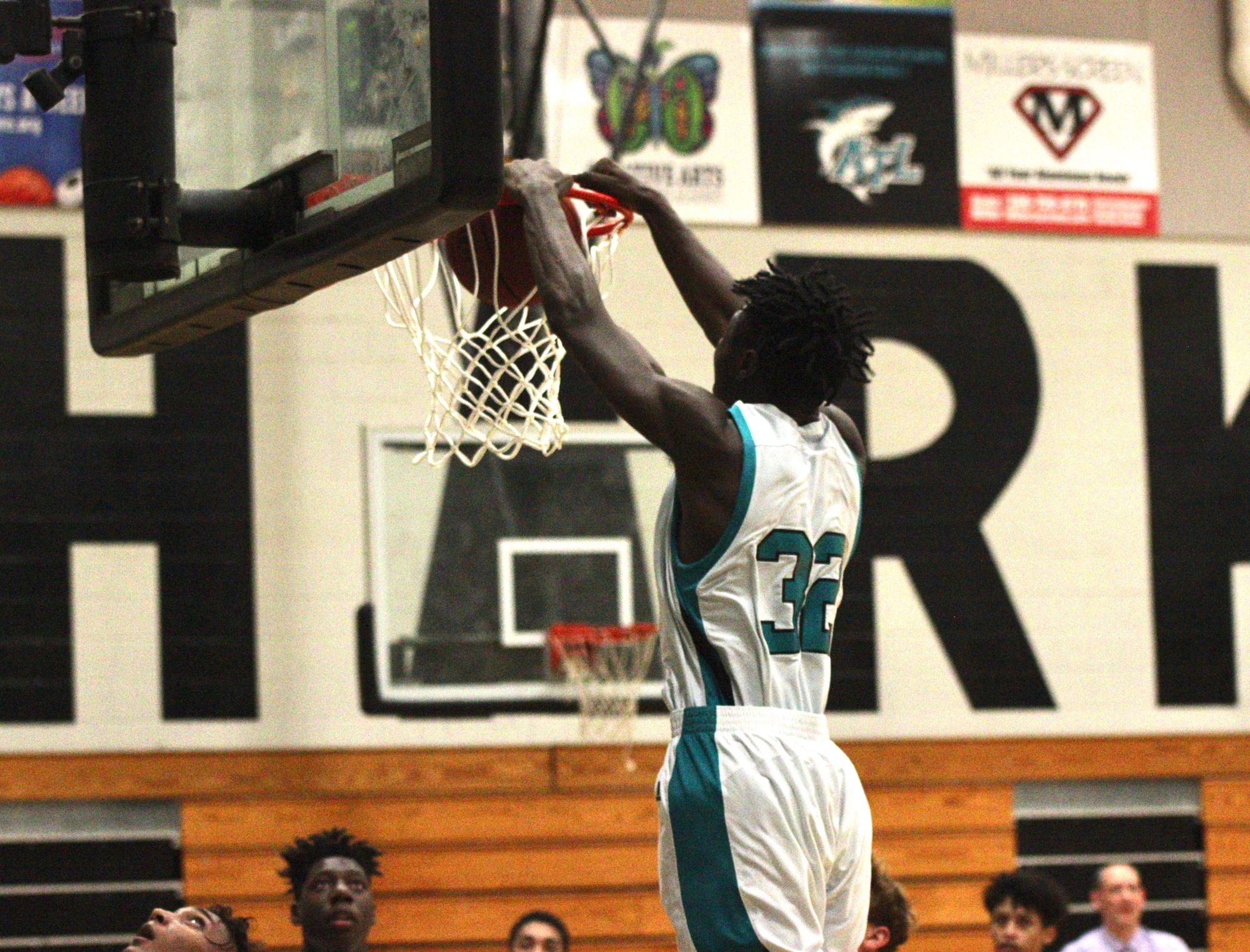 The Sharks' Dewarren Bolden dunks a ball in the first half against Hudson. Photo by Ray Boone