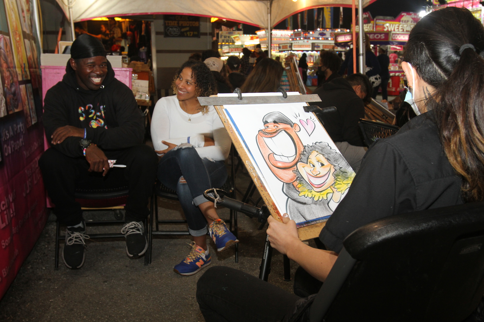 APRIL: Unique Johnson and Alane Murrell have their caricatures drawn.