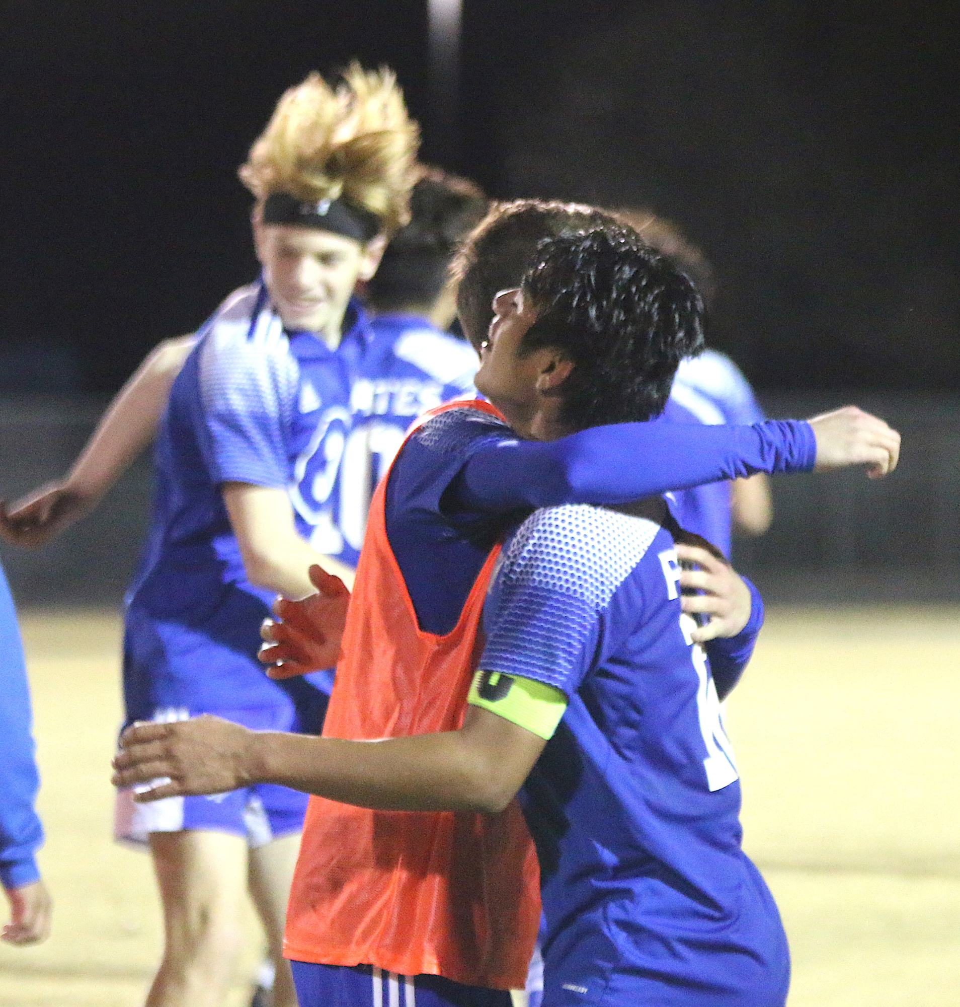 Joseph “Fuji” Powell, right, gets a hug after scoring the winning goal. Photo by Brent Woronoff