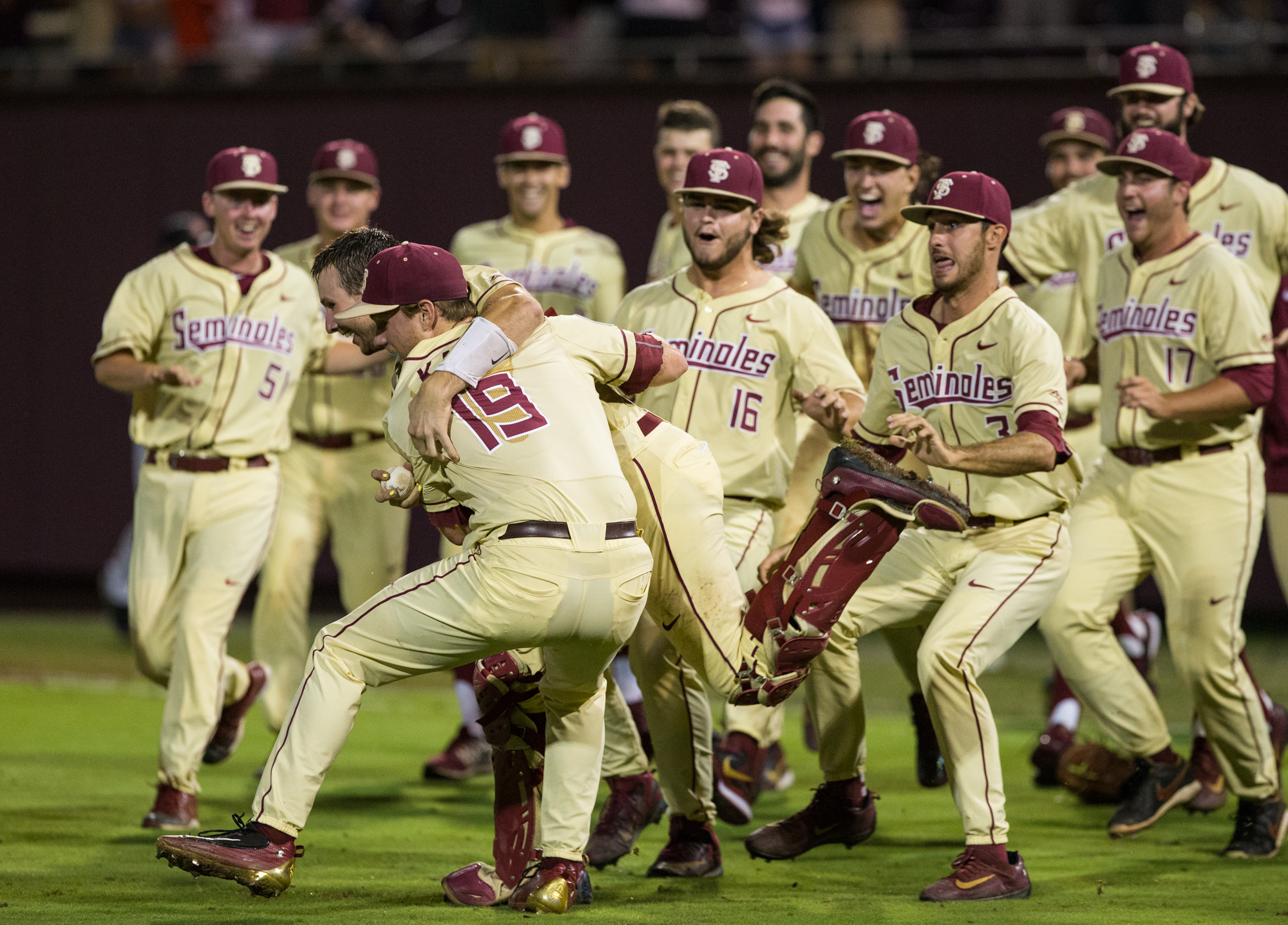 Teammates mob Andrew Karp after the final out of the Super Regional. Photo Courtesy of FSU Athletics