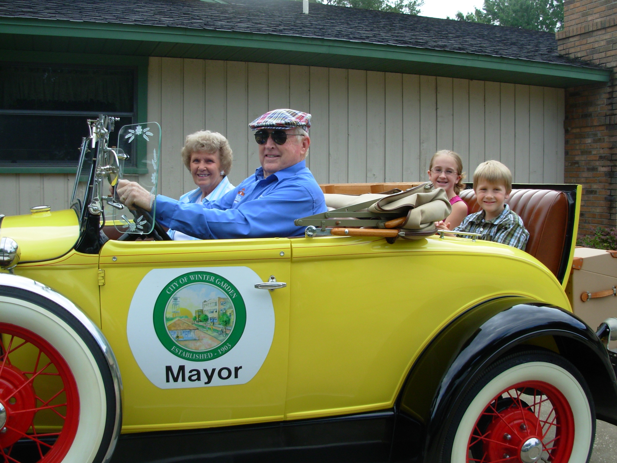 Jack and Gloria Quesinberry take two of their grandchildren, Allison Couch and Adam Couch, for a ride in his 1931 Model A.