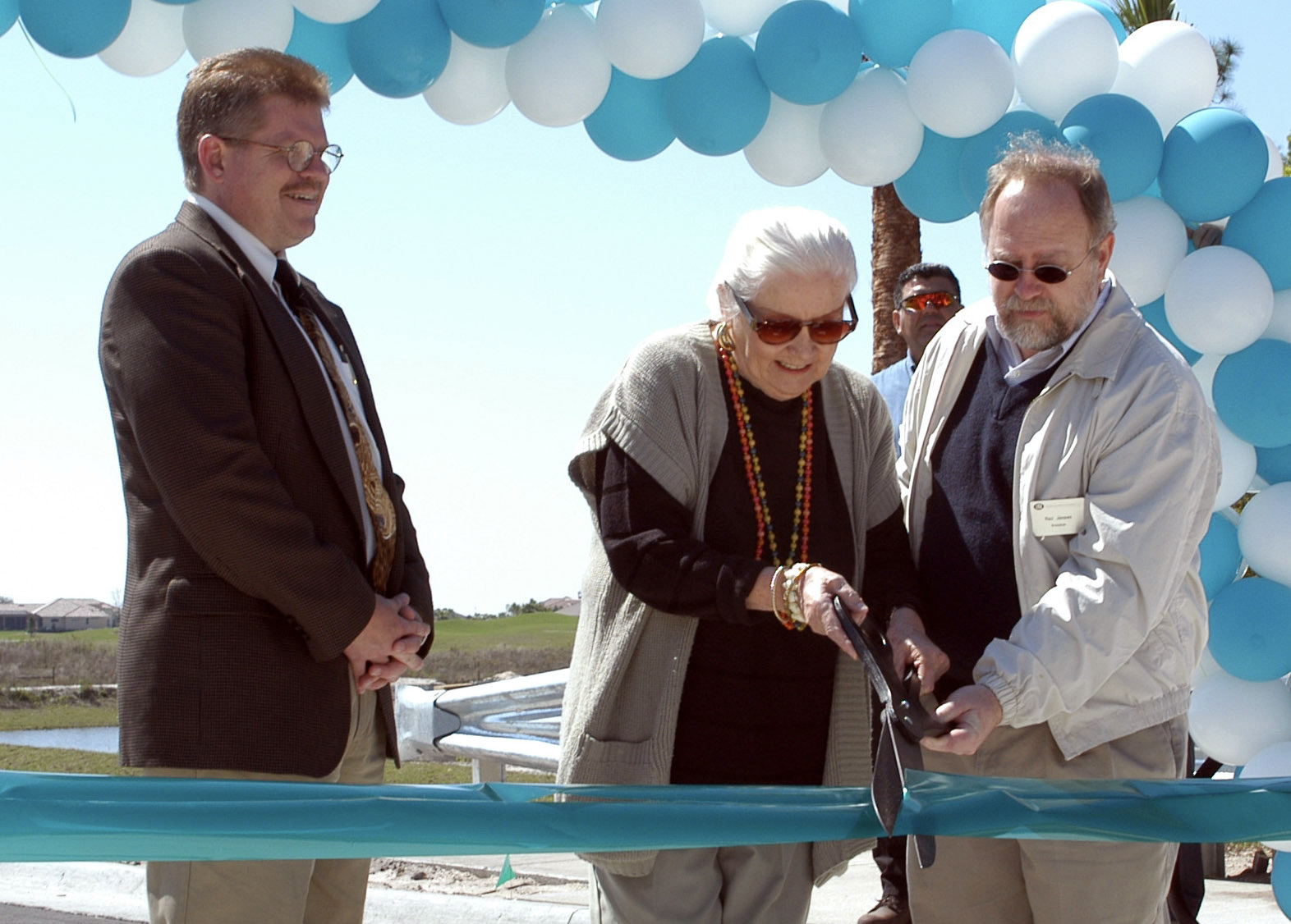 Manatee County Commissioner Jonathan Bruce, Mary Fran Carroll, and SMR President and CEO Rex Jensen perform the ribbon cutting atop the Mary Fran Carroll Bridge in 2004. Courtesy photo.