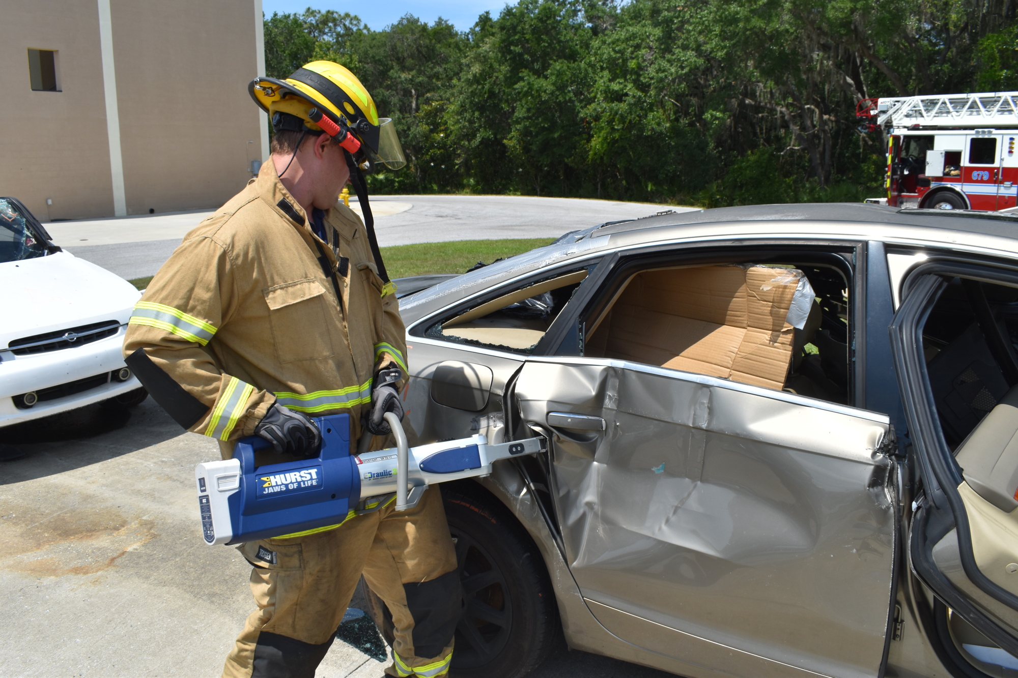 Firefighter Bret Kanapaux uses a spreader to pry open a car door during extrication training at East Manatee Fire Rescue Station 1. Training helped everything go just right during Karen Guest's rescue.