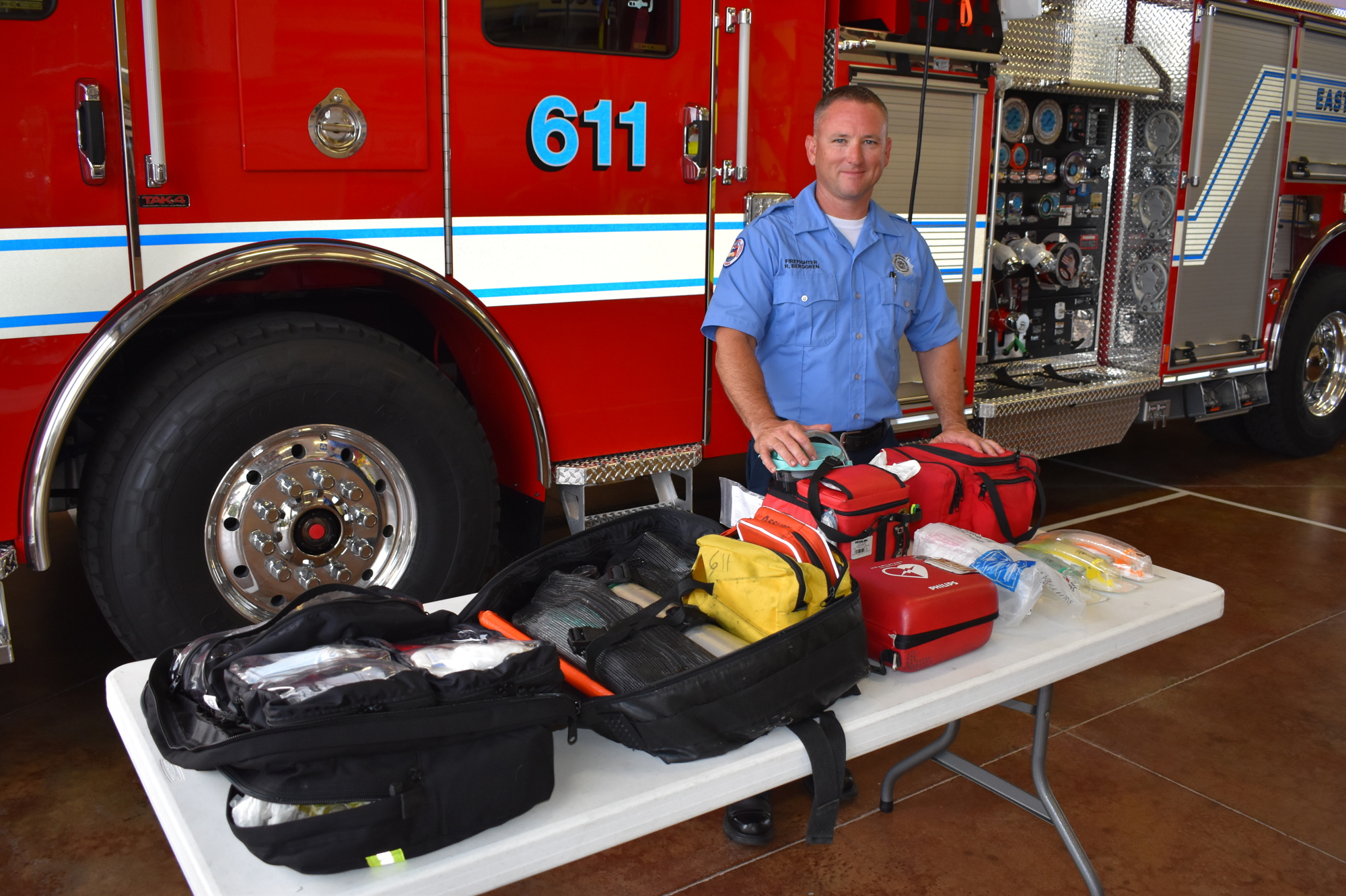 Firefighter Ryan Berggren lays out the Basic Life Support equipment the firefighters are currently utilizing including automated defibrillators, and oxygen and first aid equipment.