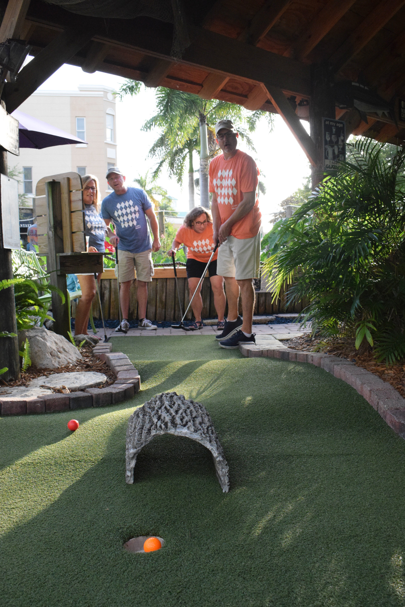 Parrish's Cassie and Josh Brandt and Lakewood Ranch's Julie Junk watch as Mike Junk gets a hole-in-one on his first putt in the league. (Photo by Liz Ramos)