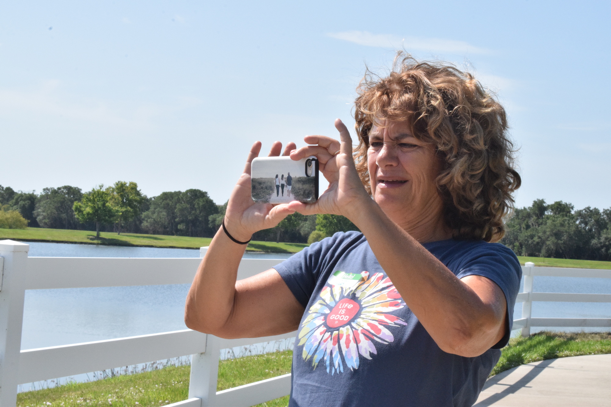 Esplanade's Shelley Chinskey takes a photo with her camera phone horizontal. 