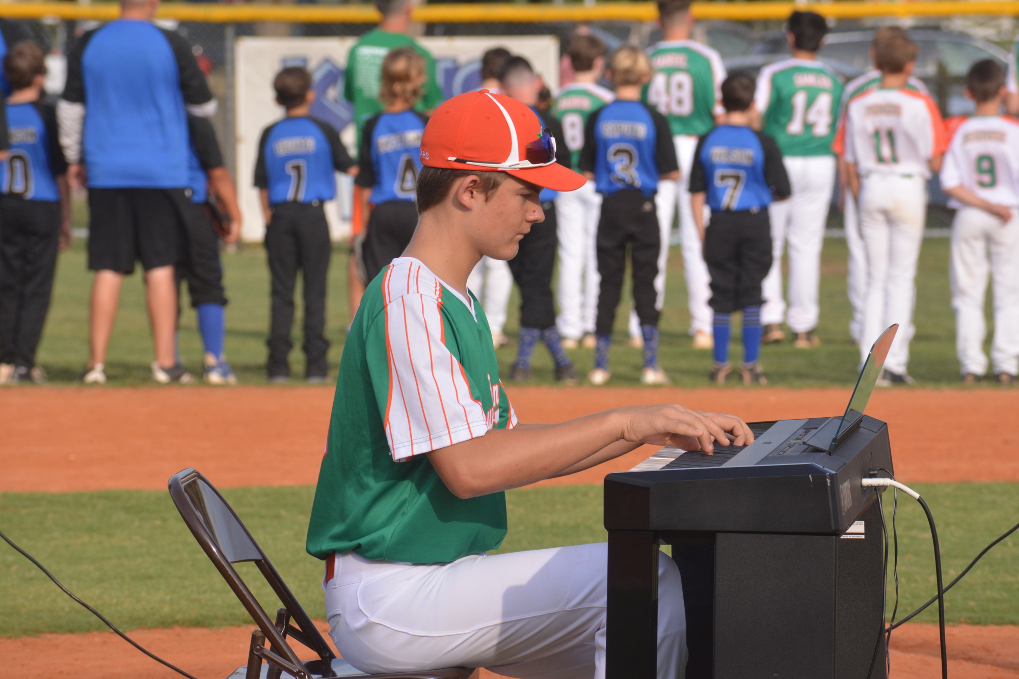 Trevor Kovatch plays the National Anthem on a piano during Lakewood Ranch Little League's All-Star opening ceremony June 22.