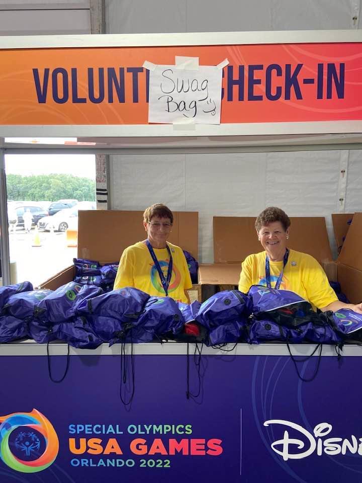 OBTS Lions Club Past Presidents Bobbie Cheh and Mary Yochum work the ESPN Wide World of Sports welcome volunteer tent, handing out over 300 backpacks. Courtesy photo