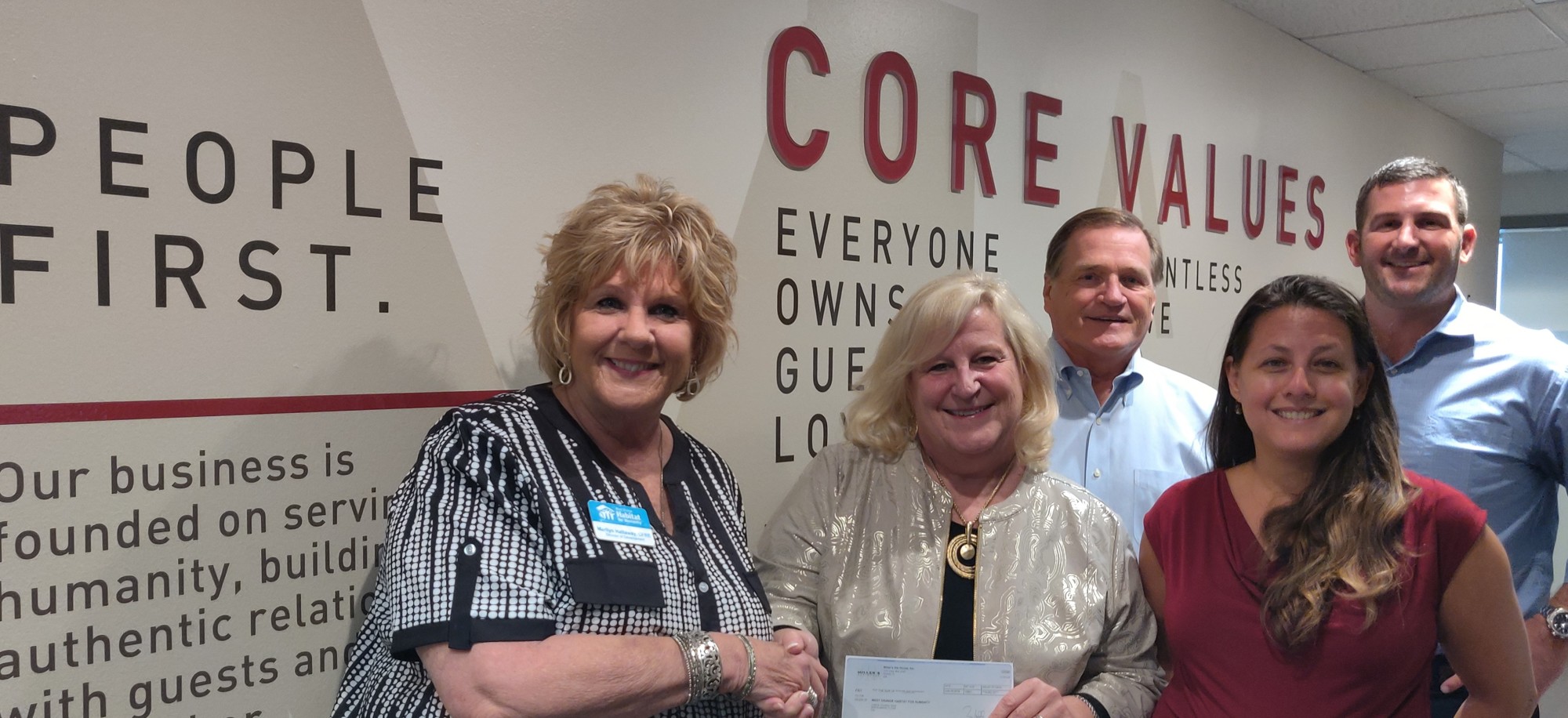 Representatives from Miller’s Ale House presented a check to Marilyn Hattaway, executive director of West Orange Habitat for Humanity.