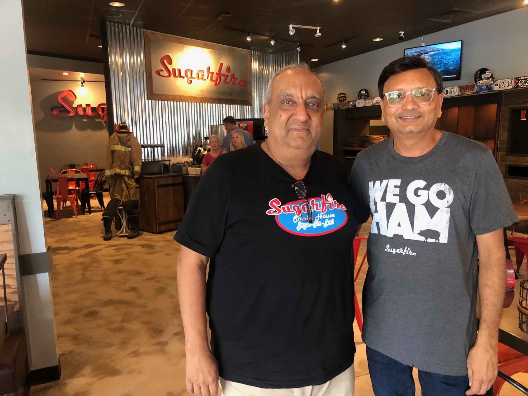Two of the franchise owners, Anil Dharna, left, and Shy Patel, at the 12959 Atlantic Blvd. Sugarfire Smoke House.