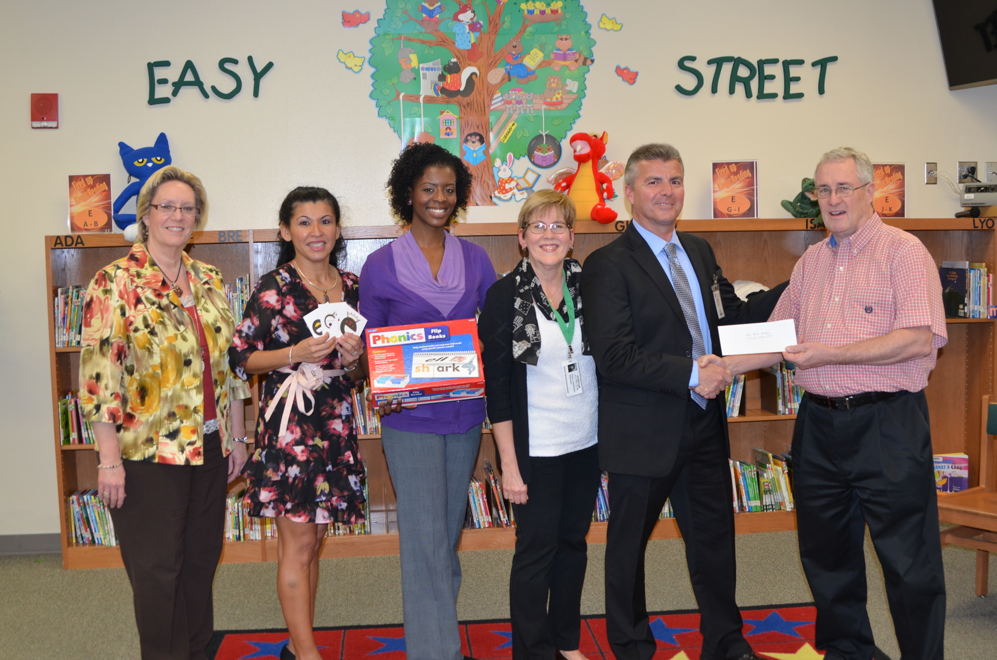 Mindi Smith, executive area director of the West Learning Community; Daisy Mitchell; Dillard Street music teacher Kelley Bell; Karen Hausmann; DSES Assistant Principal Carl Sousa; and Pastor Rusty Belcher of First United Methodist Church of Winter Garden.