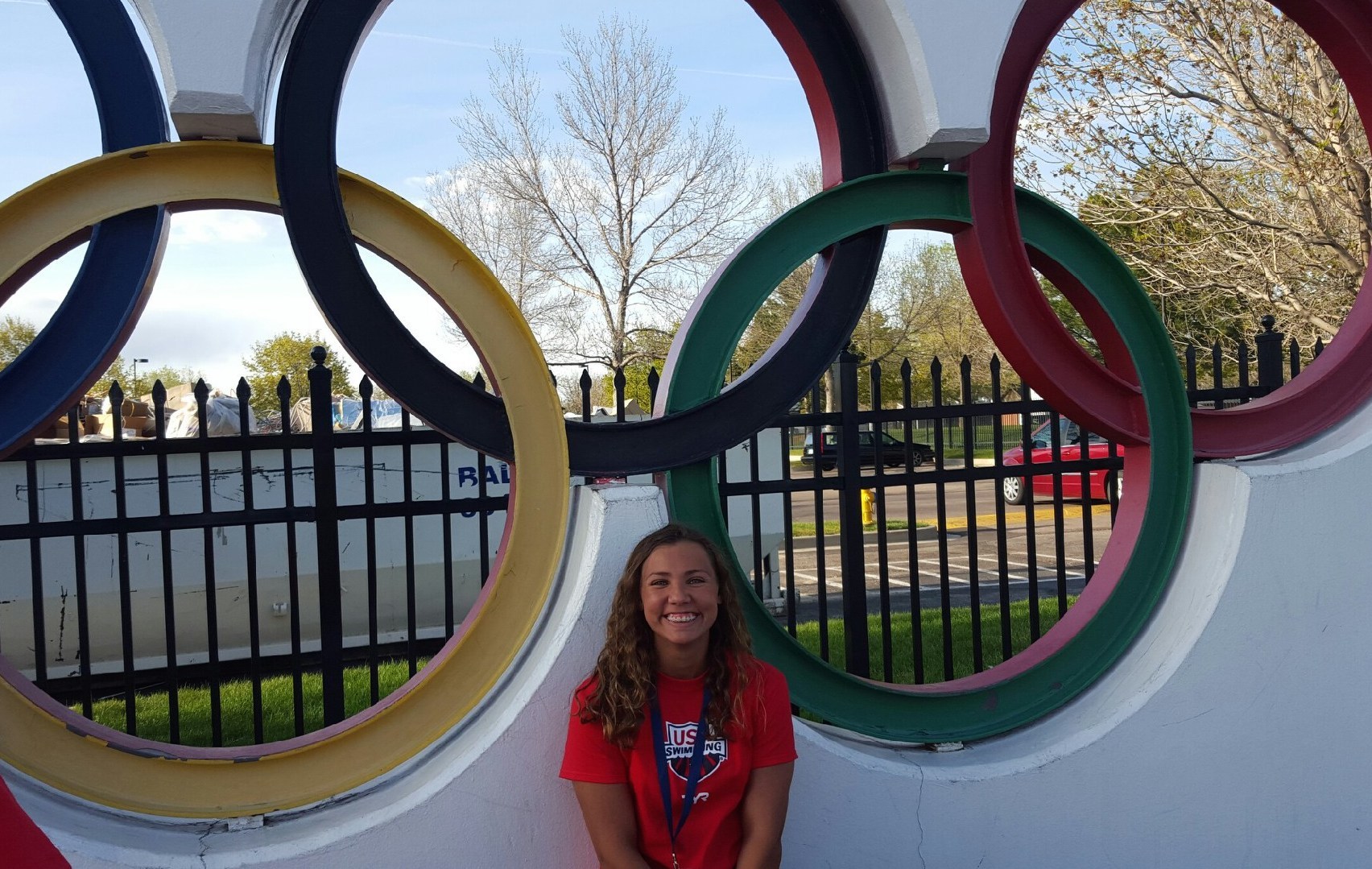 Sofia Bernard poses in front of the Olympic rings at the training facility in Colorado Springs.