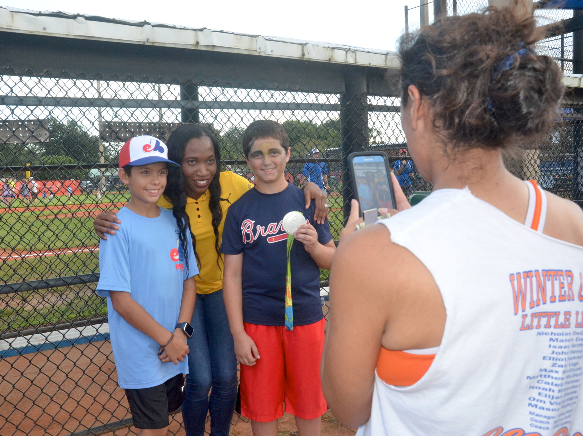 Little Leaguers from Winter Garden took advantage of the opportunity to meet an Olympic medalist when Novlene Williams-Mills stopped by the opening ceremonies to throw out the first pitch.