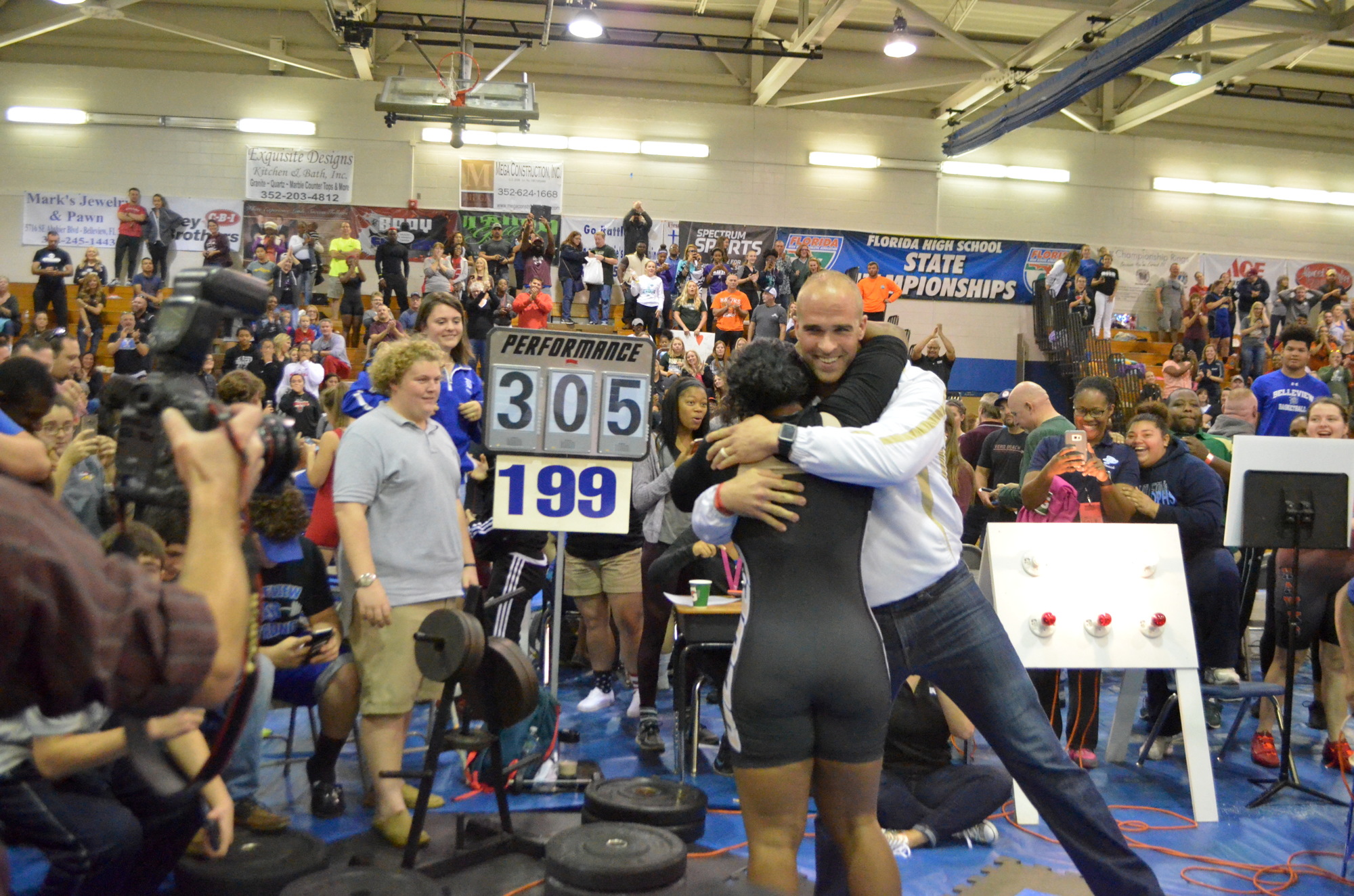 Victoria Jefferson hugs coach Jason Boltus after setting her record. Courtesy FHSAA