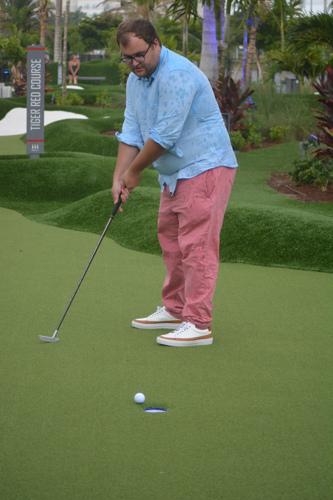 Ryan Kohn watches his putt at PopStroke. The putting and dining experience co-owned by Tiger Woods' TGR Ventures opened at The Mall at UTC in April.