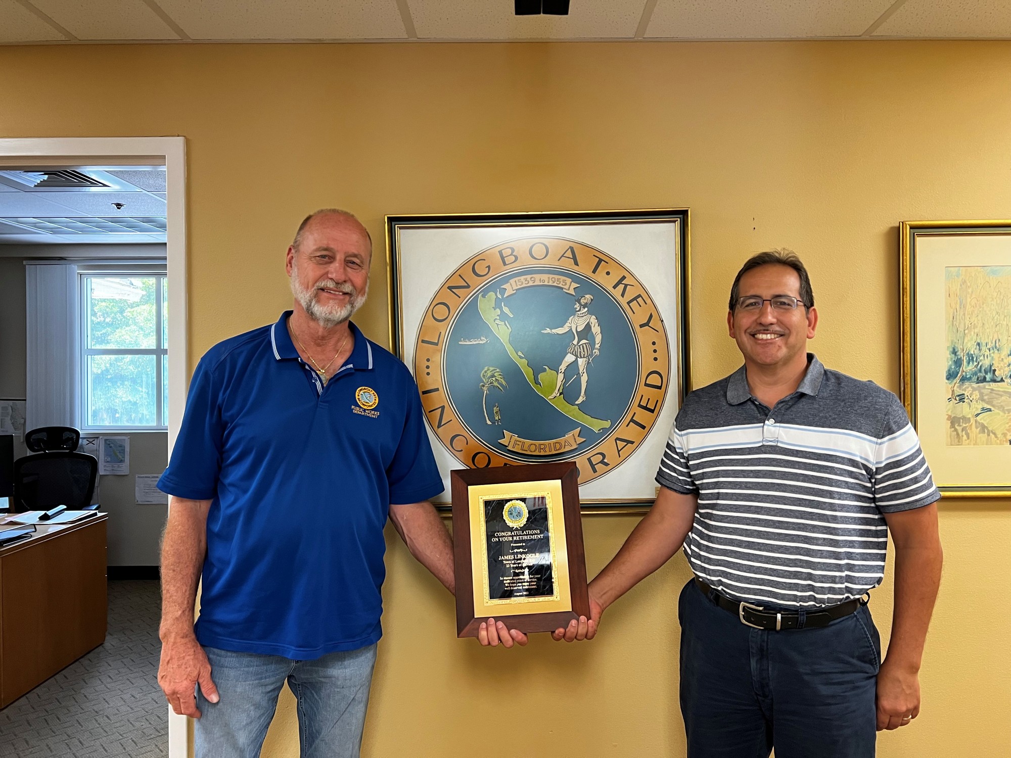 James Linkogle, left, receives a plaque commemorating his service from Isaac Brownman. (courtesy photo)