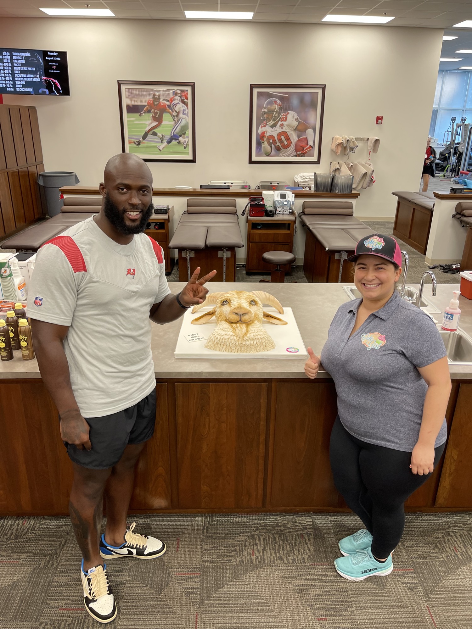 Tampa Bay Buccaneers running back Leonard Fournette, left, placed the order for the $800 GOAT cake, which was made by The Cake Girl's Kristina Lavallee. (Courtesy photo)